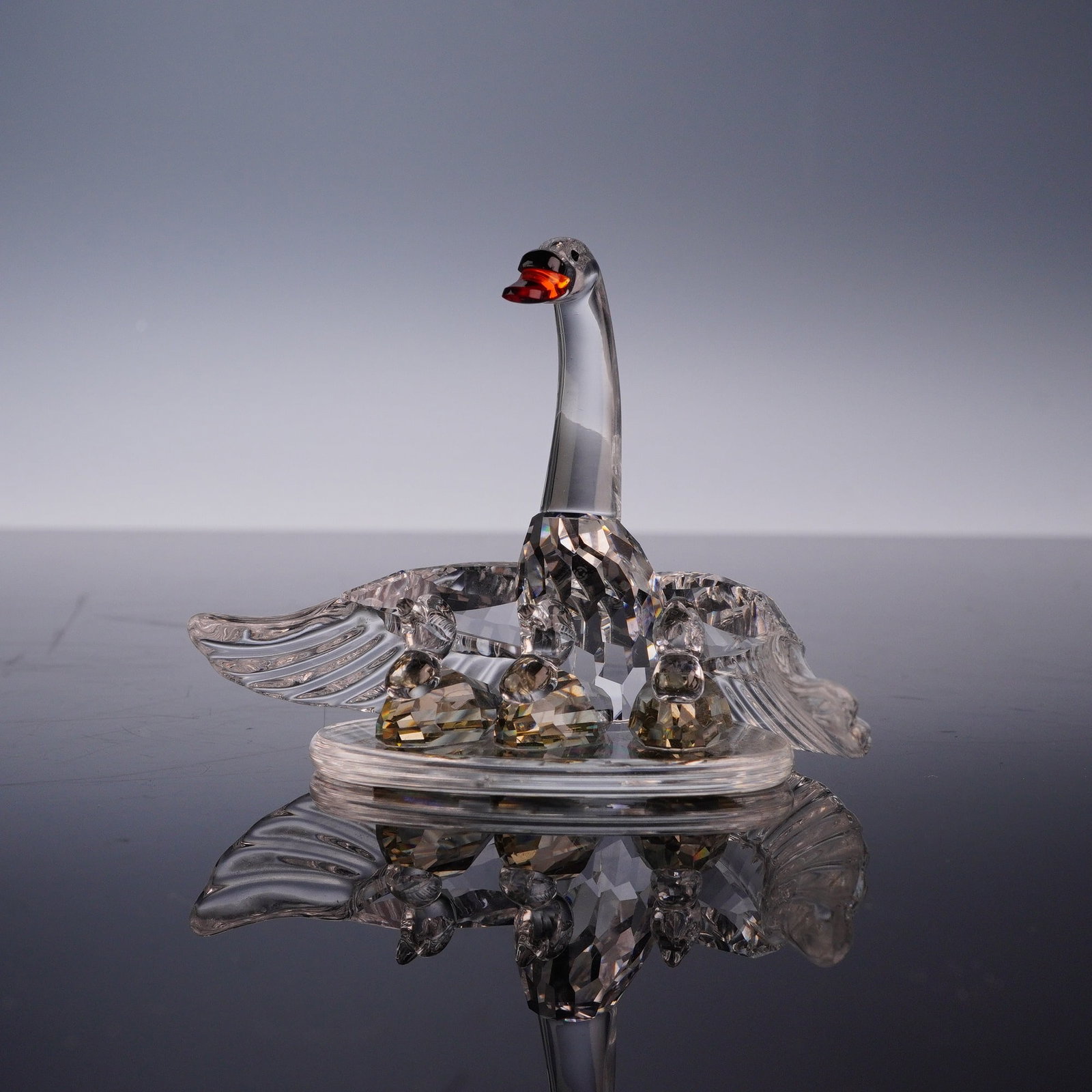 Swarovski Crystal Figurine, Swan Family: A Swarovski lead crystal figurine from the Silver Crystal collection titled Swan Family. The grouping features a mother swan with a faceted body and outstretched wings posed with three small, faceted