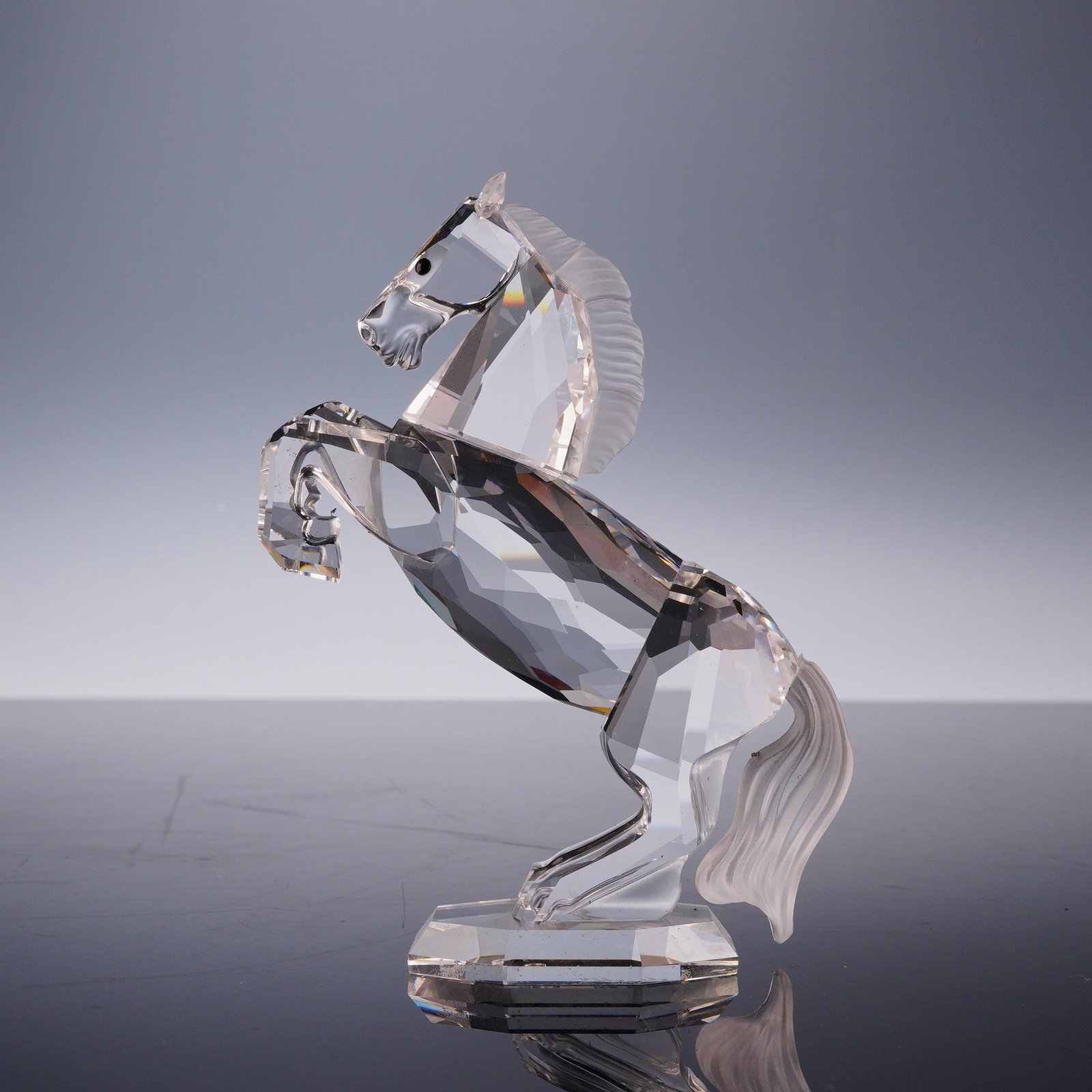 Swarovski Silver Crystal Figurine, White Stallion: This Swarovski lead crystal figurine depicts a rearing horse, identified as the White Stallion. Part of the Silver Crystal collection, the piece is characterized by a clear, multi-faceted body and