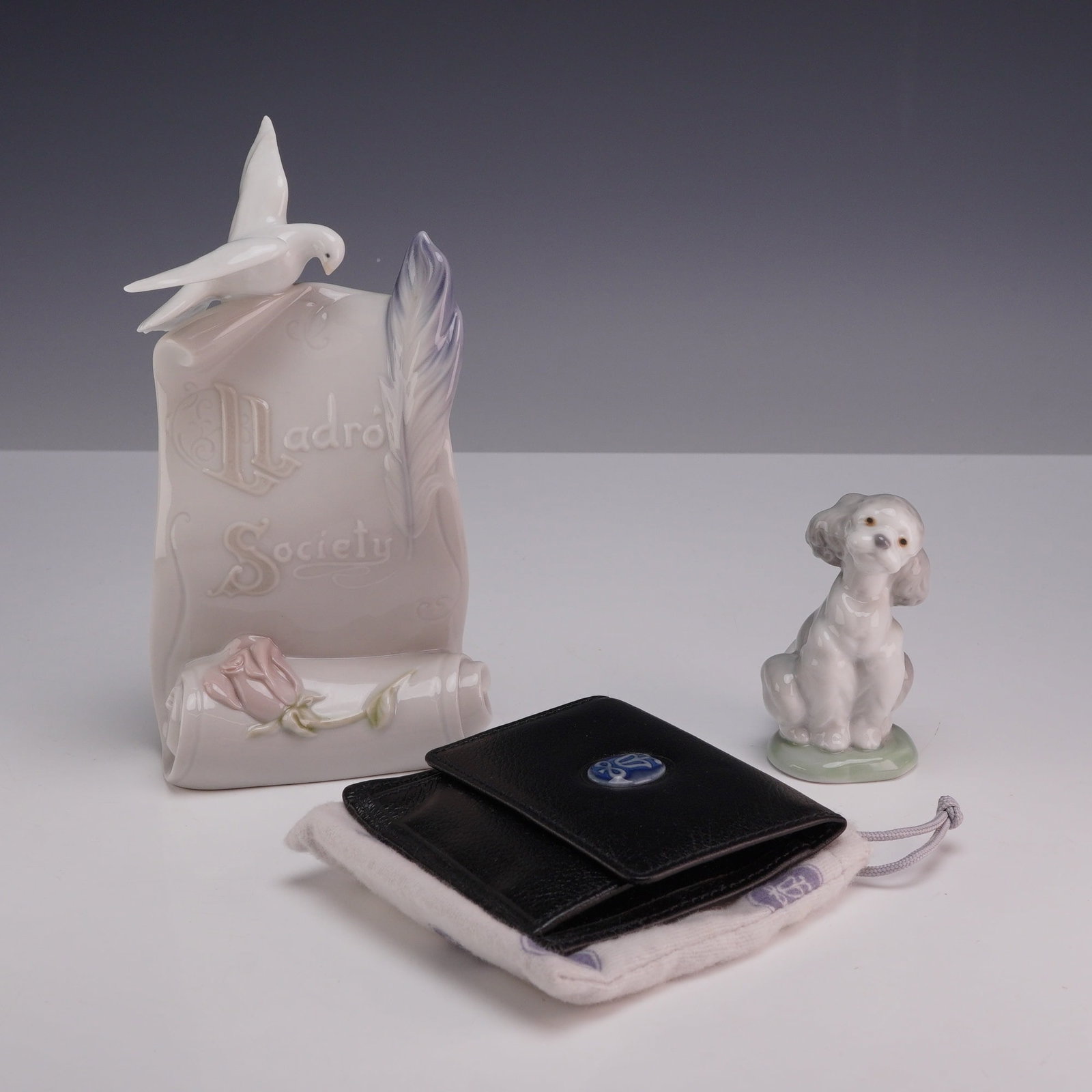 Three Lladro Collector's Society Pieces Including Scroll Plaque, Poodle Figurine, and Leather Coin (1 of 3)