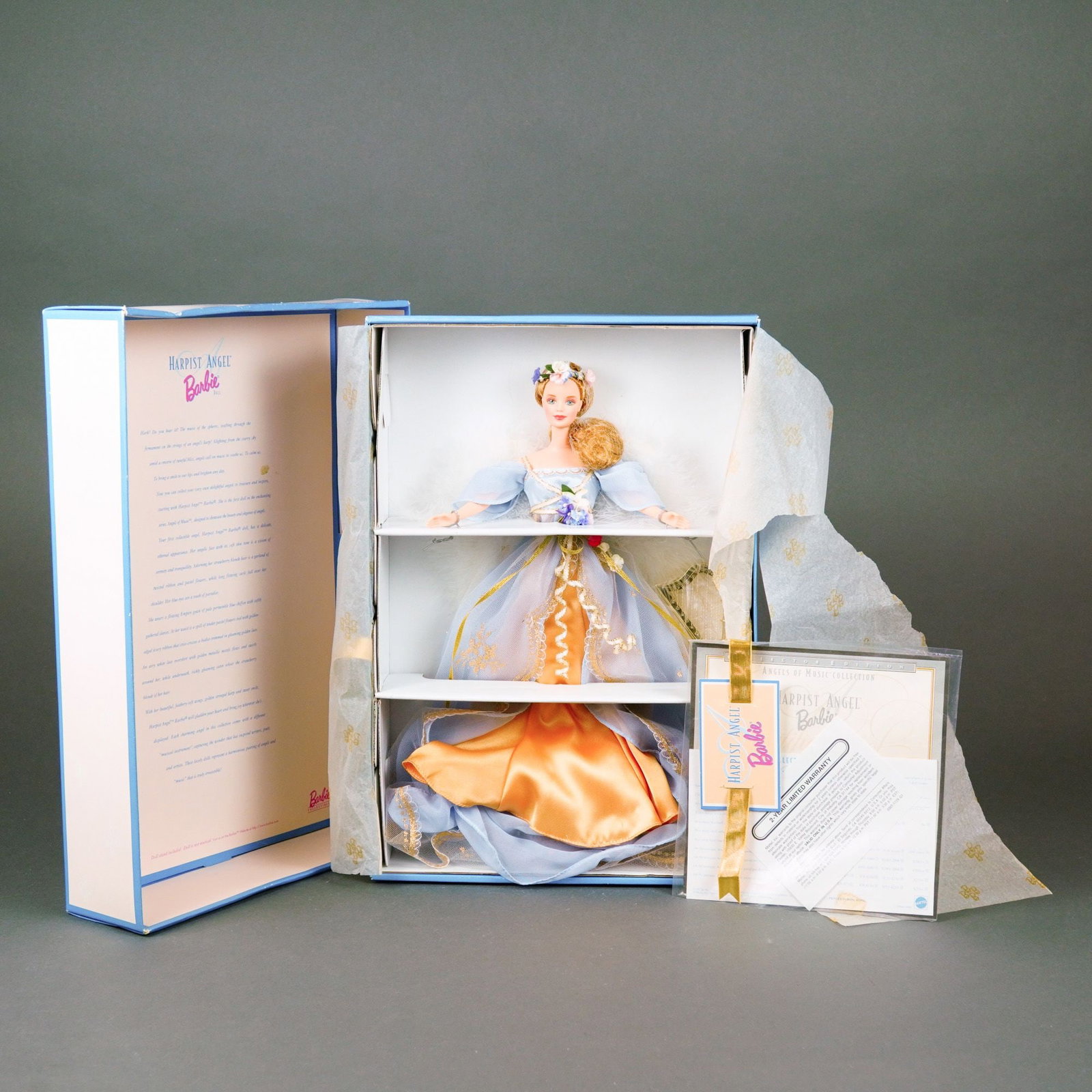 1997 Harpist Angel Barbie, Angels of Music Collection: This 1997 Collector Edition Harpist Angel Barbie is the first in the Angels of Music Collection by Mattel. The doll features an elaborate late 20th-century fantasy-style angelic ensemble. The garment