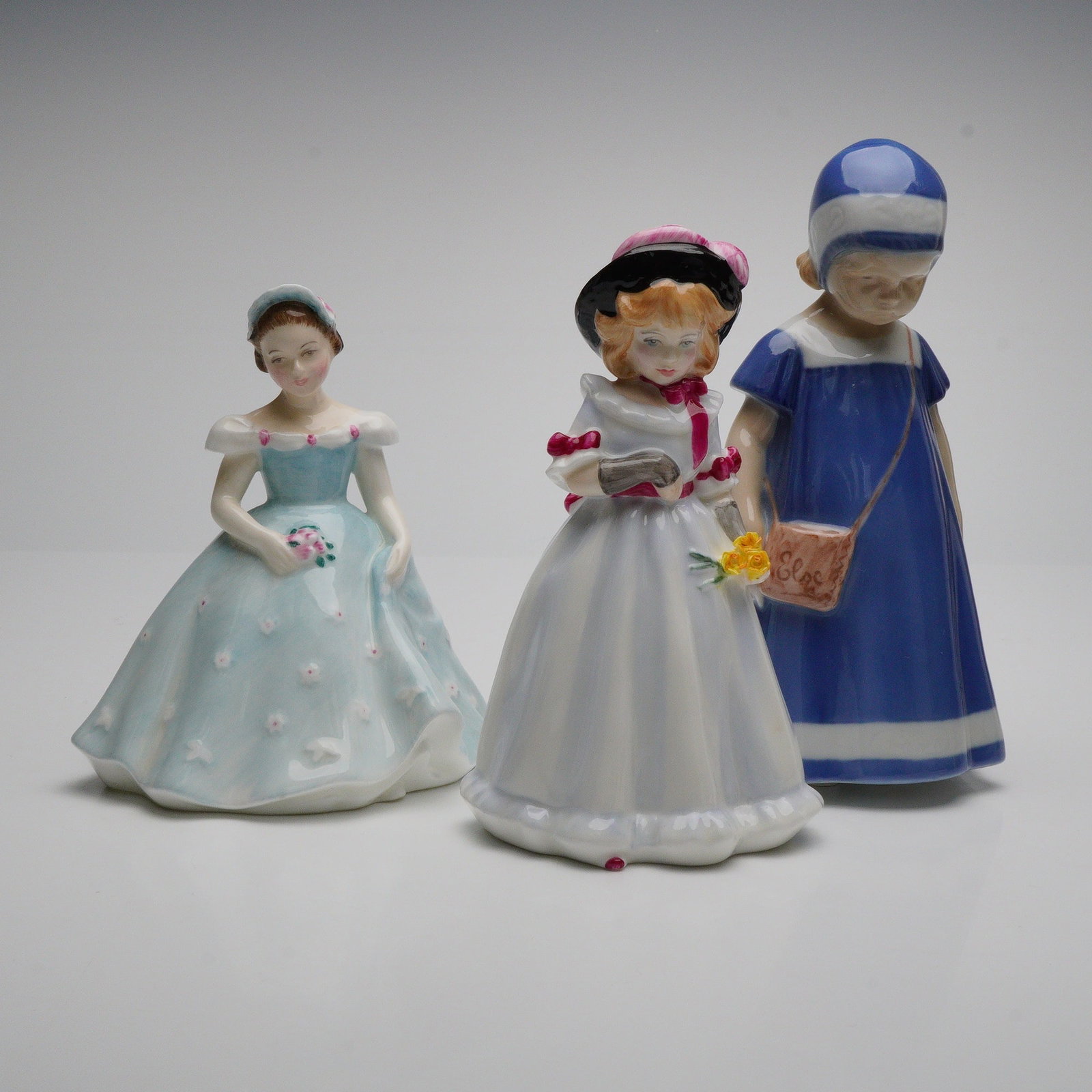 3pc Royal Doulton and Bing & Grondahl Porcelain Girl Figurines: Offered is a 3-piece assortment of vintage porcelain figurines including Royal Doulton's The Bridesmaid HN2196 and Sharon HN2978, together with Bing & Grondahl's Else 1574. Each figure is crafted in