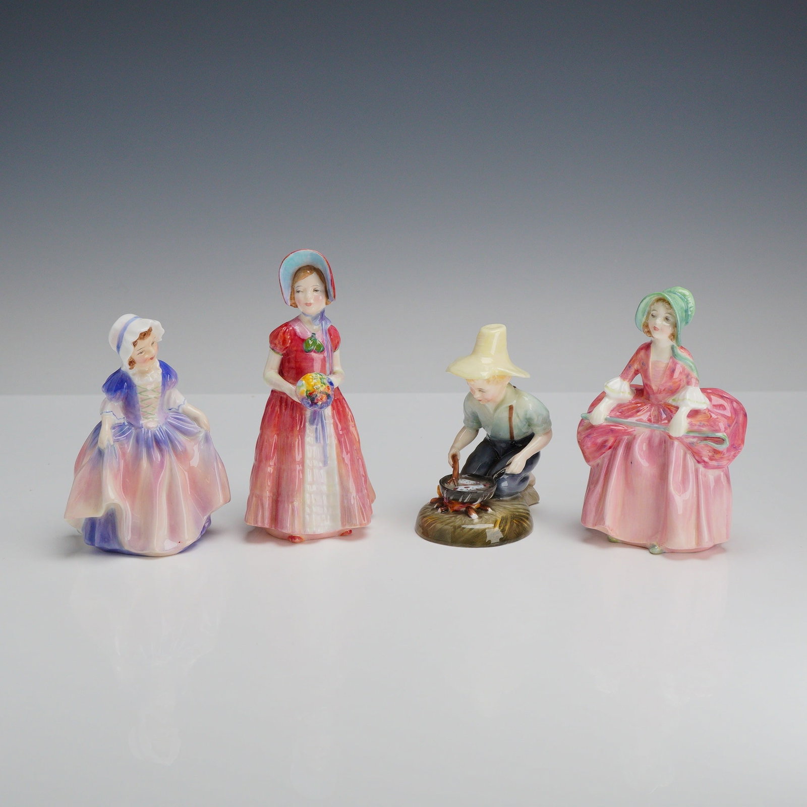 Four Royal Doulton Figurines- Diana HN1986, Bo Peep 1811, Dinky Do 1678 & River Boy 2128: This collection consists of four Royal Doulton porcelain figurines manufactured in England. Each figure is made of glazed fine bone china and features hand-painted decoration. The group includes