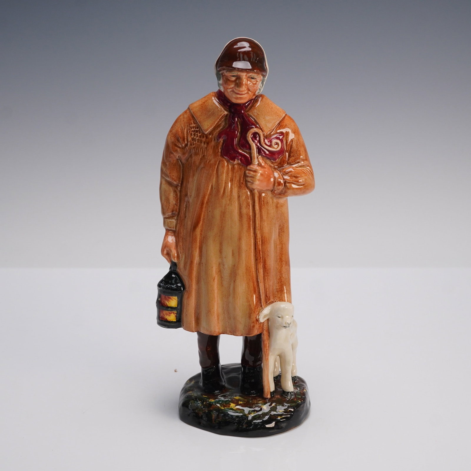 Royal Doulton Porcelain Figurine, The Shepherd HN1975: Royal Doulton porcelain figurine HN1975, titled The Shepherd. Designed by Harry Fenton and produced in England from 1945 to 1975, this hand painted figure depicts a country shepherd dressed in a long 
