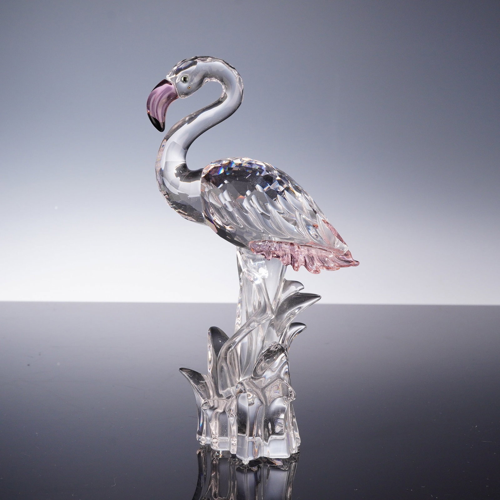 Swarovski Crystal Flamingo Figurine: A Swarovski crystal figurine of a flamingo, identified as from the Feathered Beauties collection. The bird is constructed with a multi-faceted clear crystal body and smooth neck and legs. It features