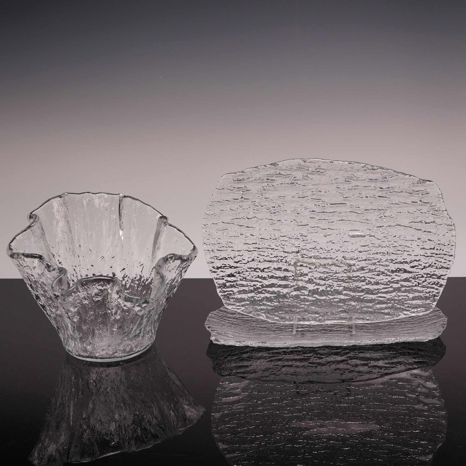 3pc Glass Platters and Bowl in Scandinavian Style Bark Glass: Crafted in a style reminiscent of mid-century Scandinavian art glass, featuring a heavily textured bark or ice glass finish. The set consists of clear glass pieces with organic, rippled exteriors and 