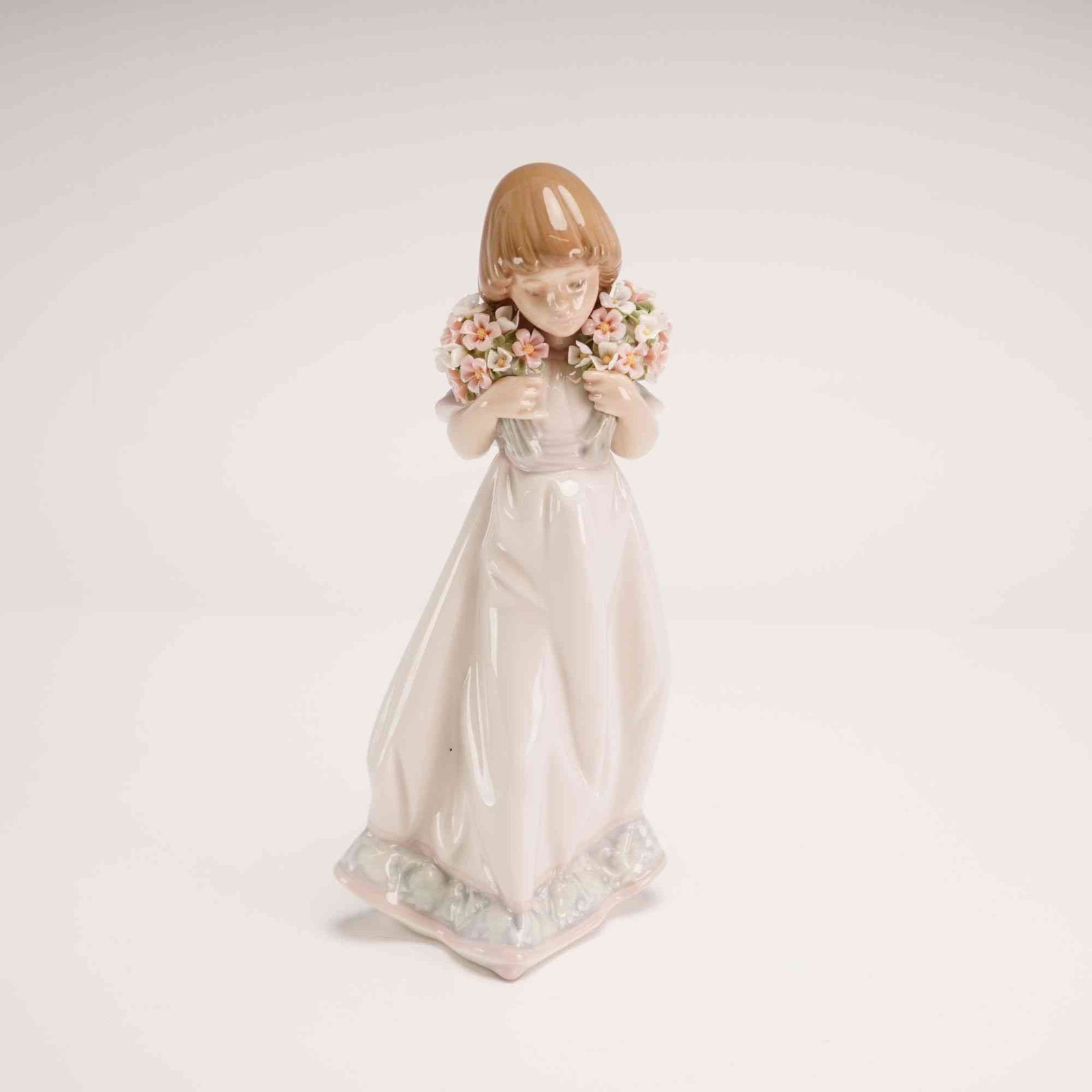 Lladro Porcelain Collectors Society 1987 Figurine Spring Bouquets 01007603 with Box: This piece was manufactured in Spain and issued as a 1987 special edition exclusively for the Lladro Collectors Society. The sculpture depicts a young girl with light brown hair in a bob cut, holding 