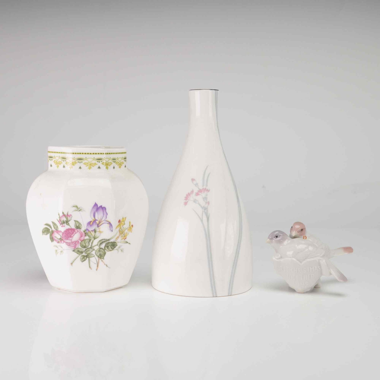 Three Royal Doulton Camila and Willow Vases and a Lladro Ornament: The first item is a Royal Doulton bone china vase in the Camilla pattern, model H.5185. It features a hexagonal body decorated with a floral bouquet consisting of a purple iris, pink roses, and yellow
