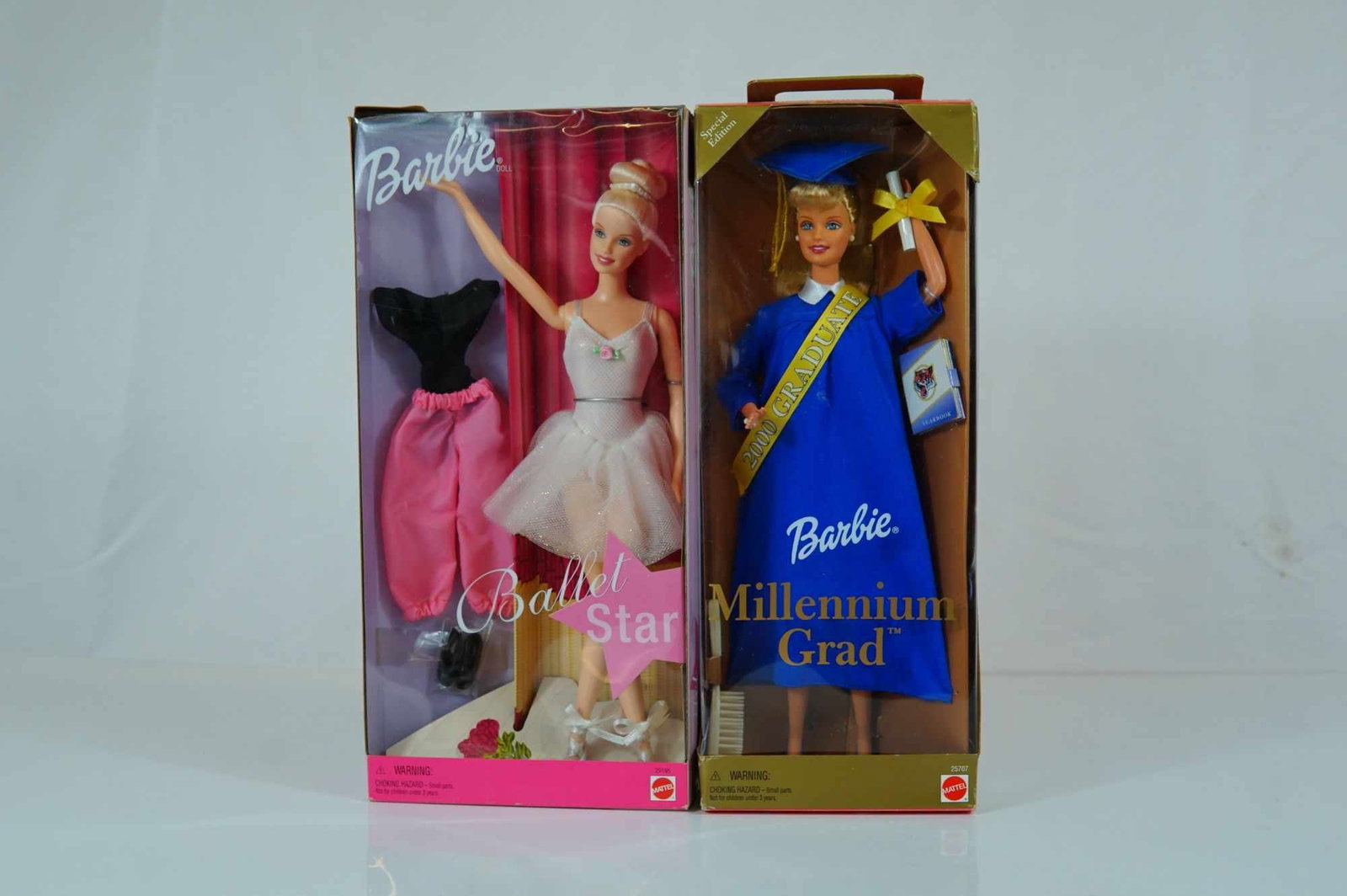 A Pair of Mattel Barbie Ballet Star and Millennium Grad Dolls, 11.5 Inches: This lot features two Mattel vinyl fashion dolls issued in 2000. The first is Ballet Star Barbie, product number 29195, featuring rooted blonde hair styled in a high ballet bun and painted blue eyes. 