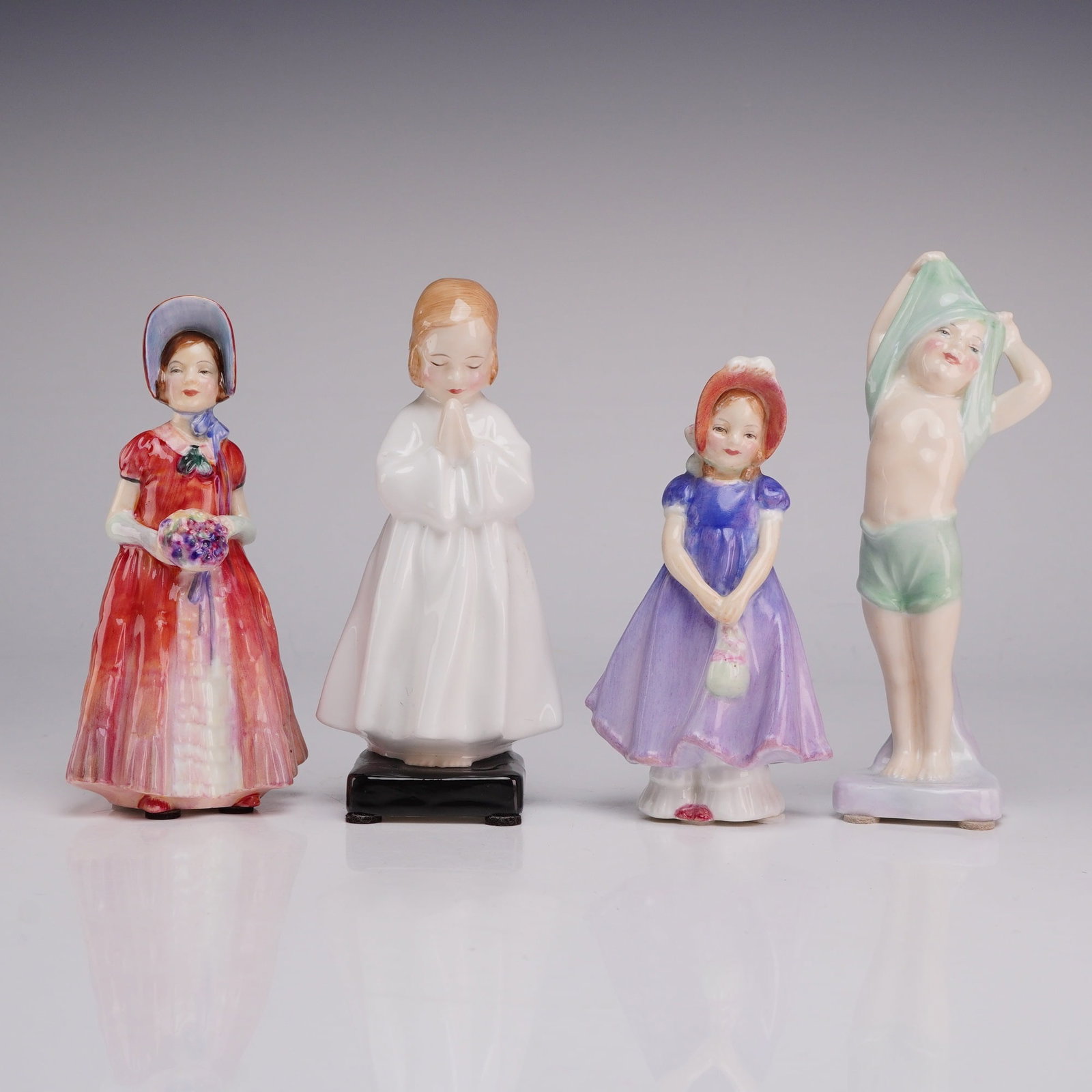 Four Royal Doulton Figurines Including Diana HN1986, Bedtime 1978, Ivy, and To Bed 1805: This group of four hand-painted bone china figurines is produced by Royal Doulton and depicts children in various poses. The collection includes the following models: Diana (HN 1986), featuring a girl