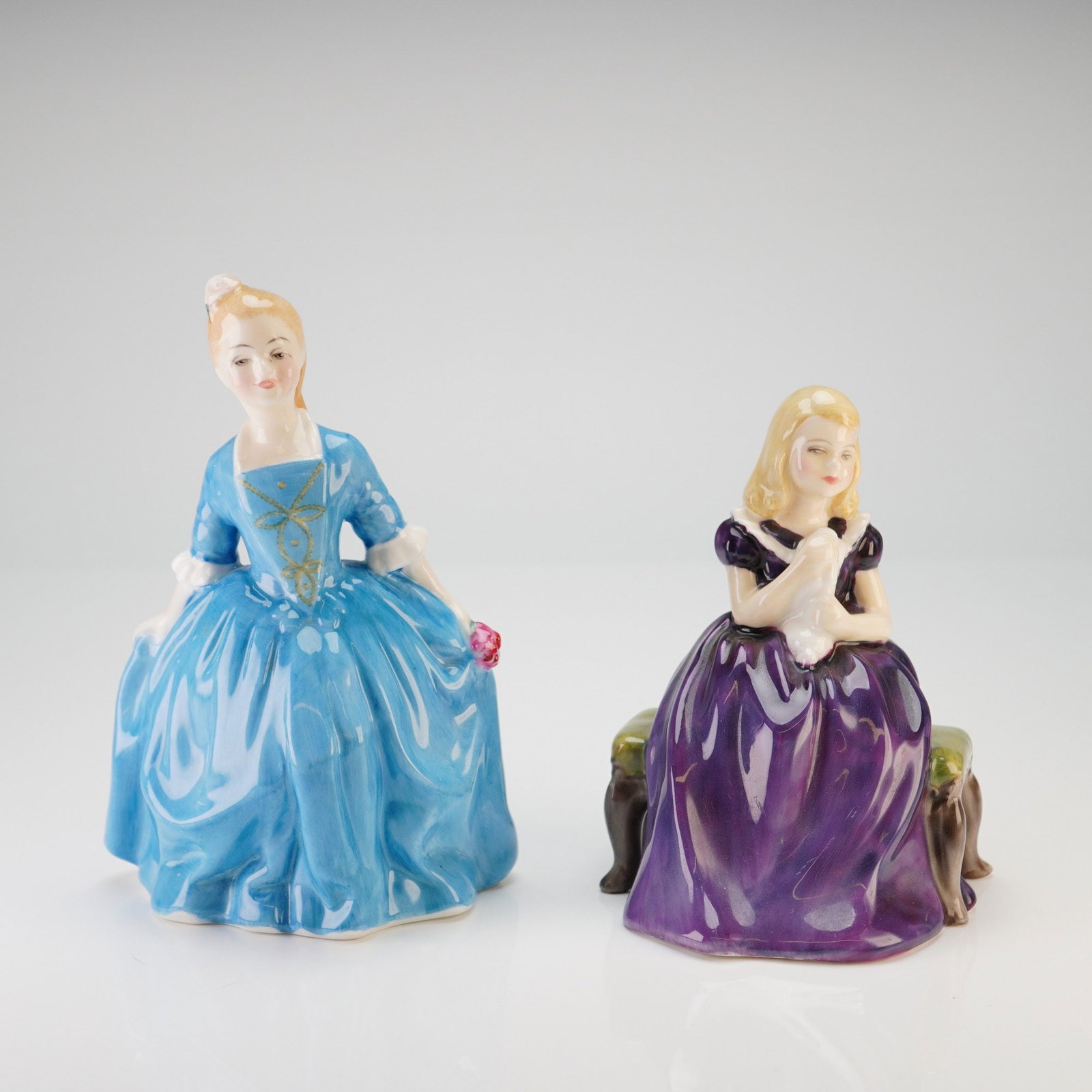 Royal Doulton, A Child from Williamsburg and Affection Figurines: A pair of Royal Doulton fine bone china figurines featuring a high-gloss glazed finish and detailed hand-painting. The first figurine, titled "A Child from Williamsburg" (HN 2154), depicts a young gir
