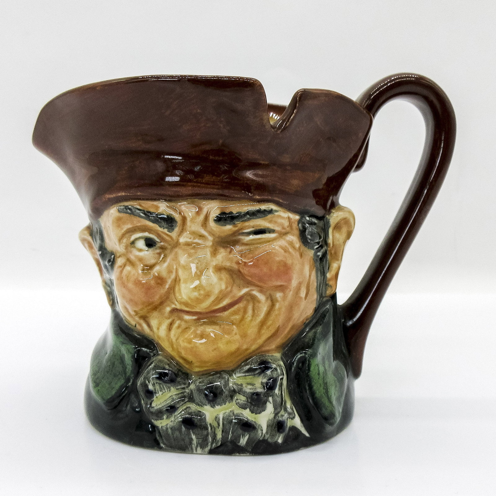 Old Charley D5527 - Small - Royal Doulton Character Jug: Brown hat; dark green coat; blue polka- dot bow tie. " Ten o'clock and all's well" was the familiar call of the Charlies, watchmen who originated during the reign of Charles II and were named after hi