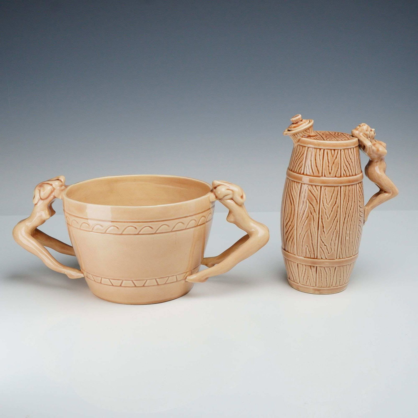 2pc Vintage Dorothy Kindell Ceramic Nude Pinup Decanter and Bowl: A collection of vintage ceramic figural pieces by noted California ceramic artist Dorothy Kindell, designed in her signature mid-century pinup style. The first piece is a decanter with stopper which f