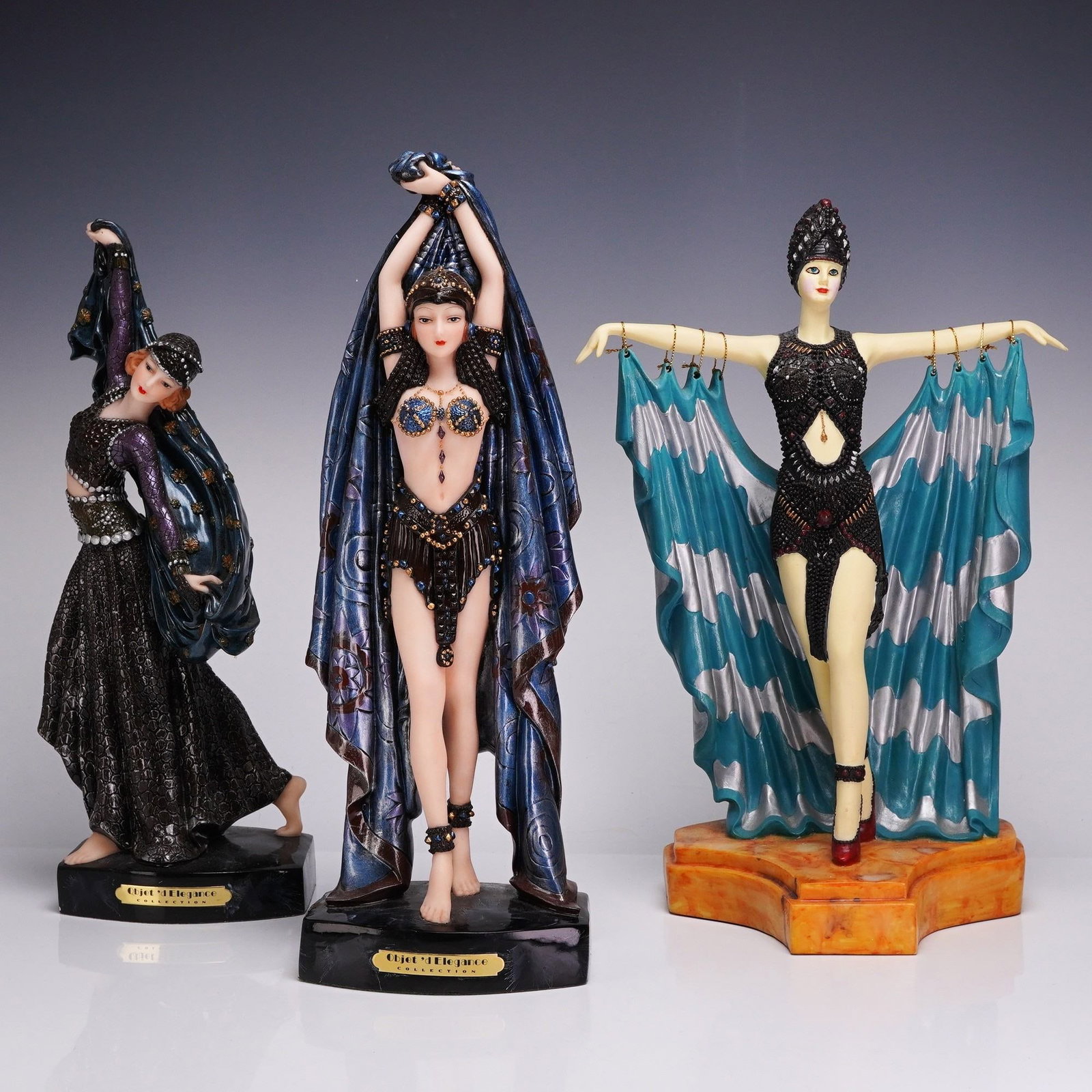 3pc Objet d'Elegance Collection Dance of the Seven Veils Resin Figurines: This lot consists of three figurines from the Objet d'Elegance Collection, specifically identified as part of the Dance of the Seven Veils series. These Art Deco style figures are crafted from