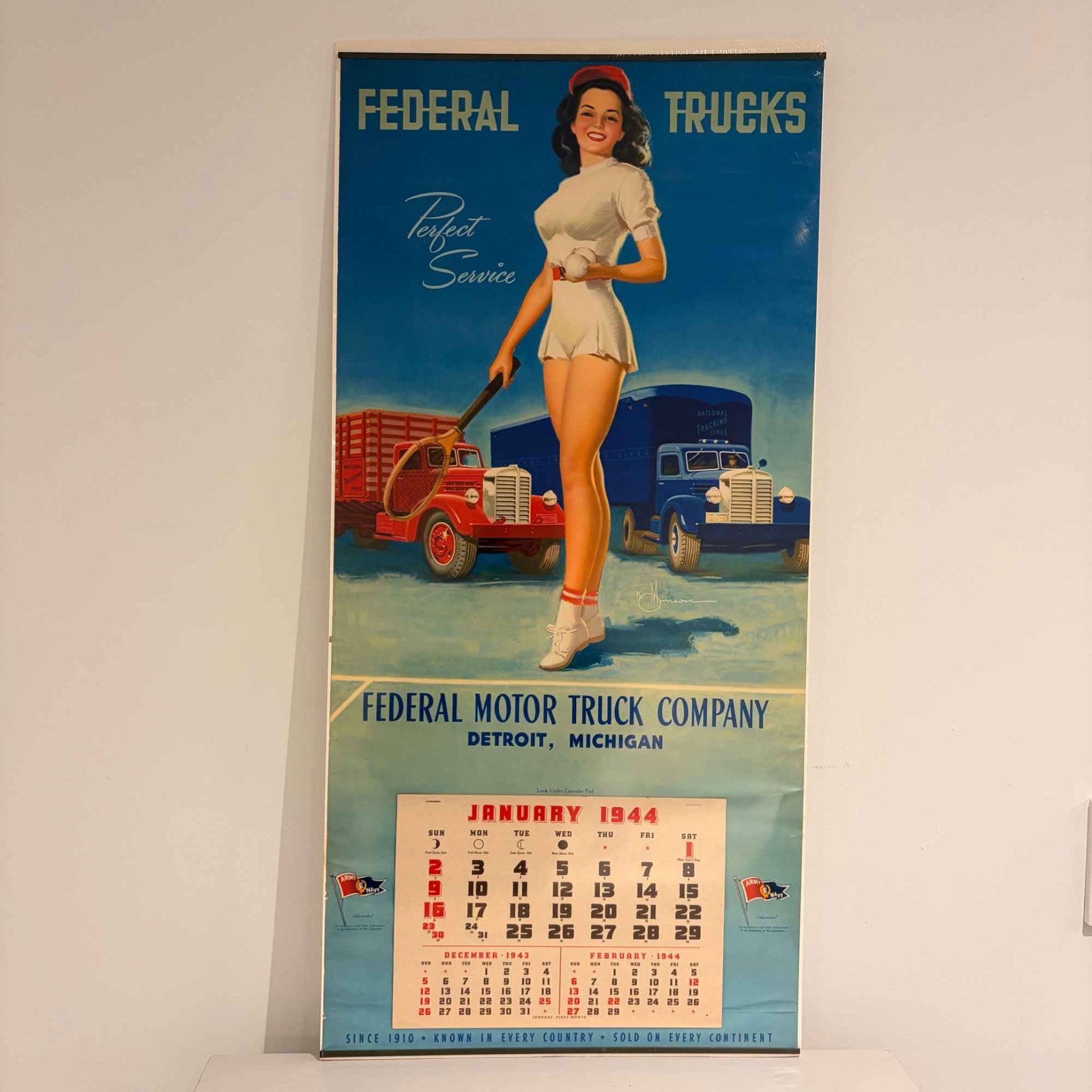 1944 Federal Motor Truck Company Advertising Calendar w/ Knute Munson Pin-Up: A large-format wrapped lithographed paper advertising wall calendar for the Federal Motor Truck Company of Detroit, Michigan, dated 1944. The upper section features a pin-up style illustration by arti