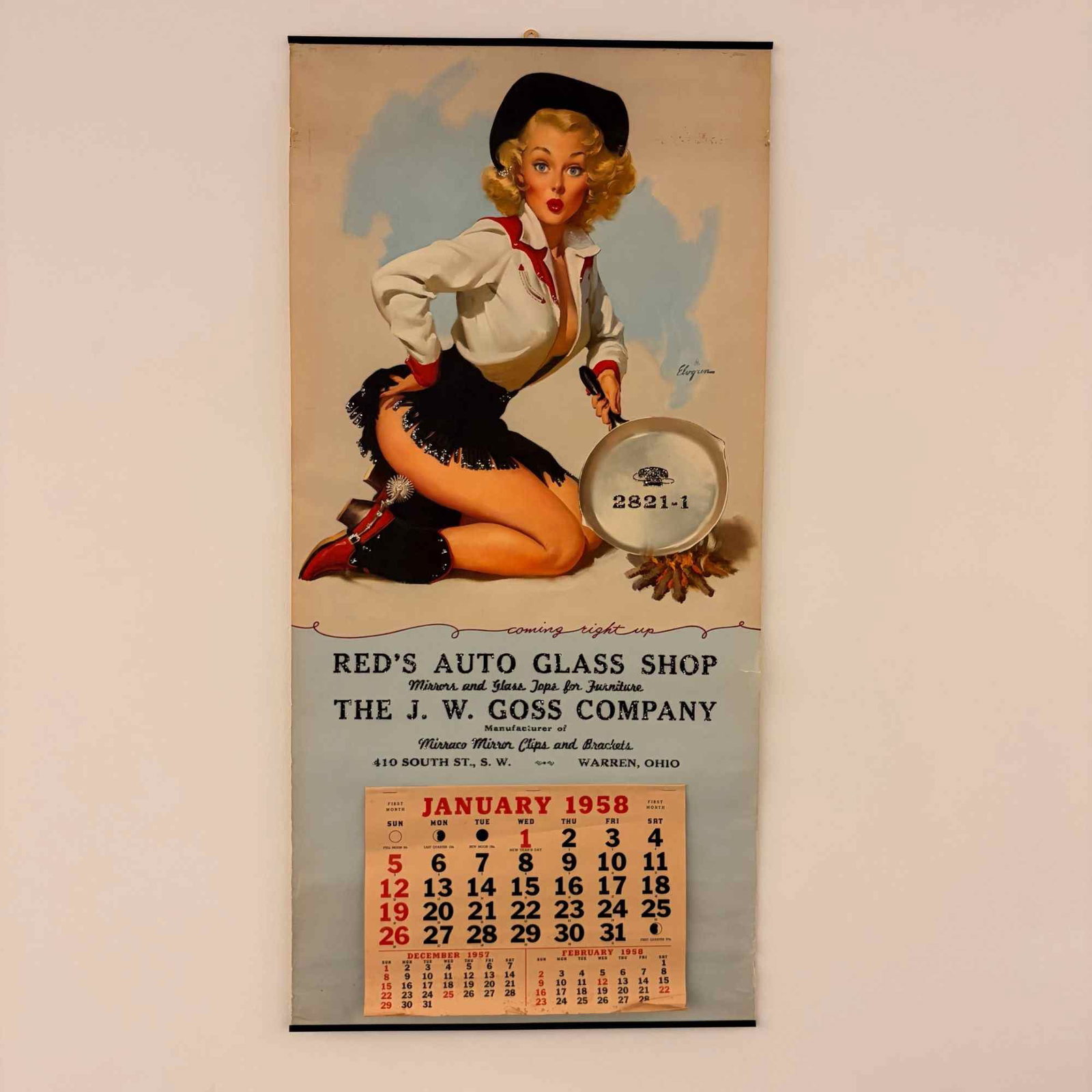 1958 Advertising Pin-Up Wall Calendar with Art by Gil Elvgren: This original 1958 advertising wall calendar features a pin-up illustration by artist Gil Elvgren. The artwork depicts a blonde woman in Western-style clothing, including a white shirt, black fringed 