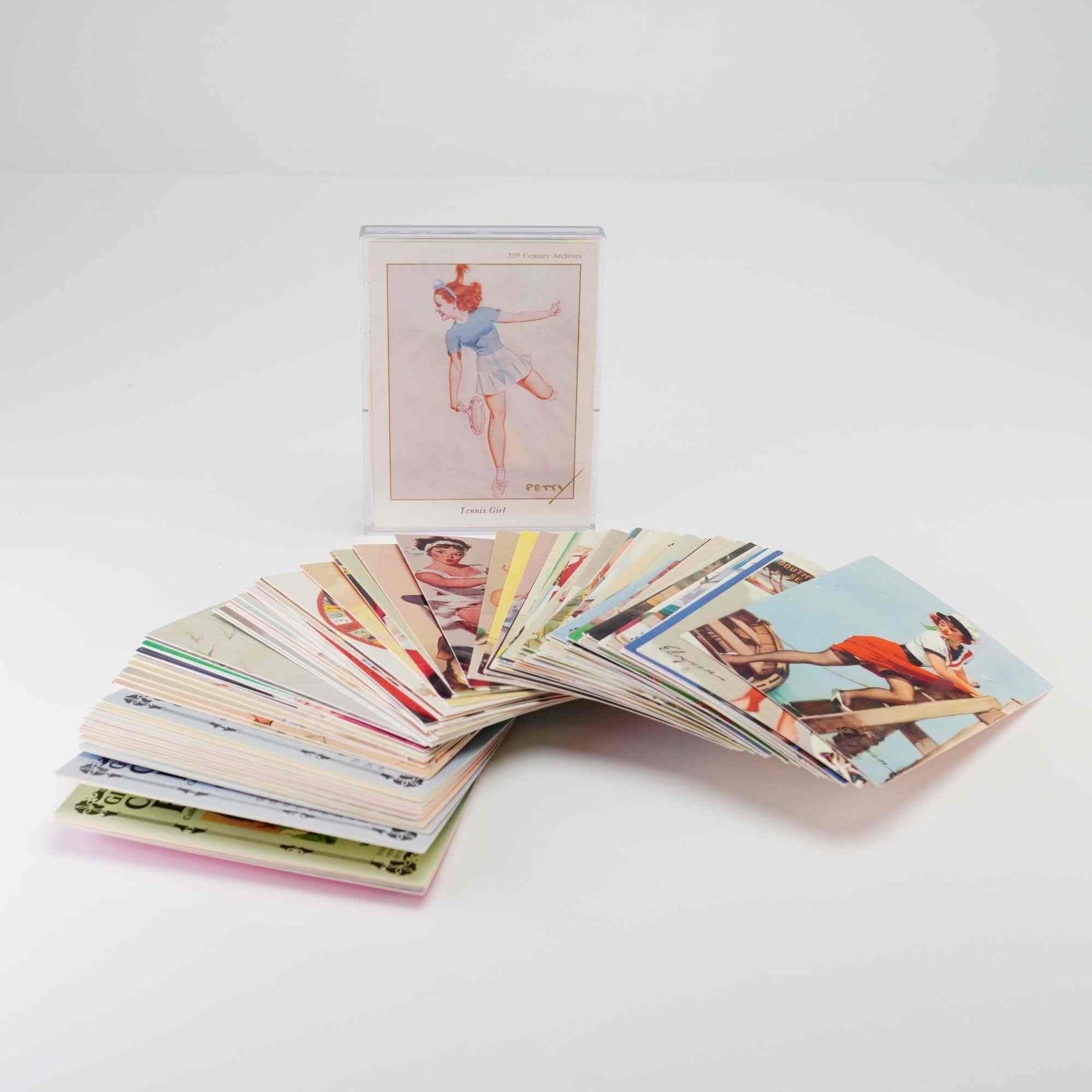 A Collection of Gil Elvgren and George Petty Pin-Up Collector Trading Cards: This erotica collectors card grouping consists of a large assortment of modern trading cards reproducing mid-20th-century pin-up illustrations. The lot includes a significant portion of the Gil Elvgre