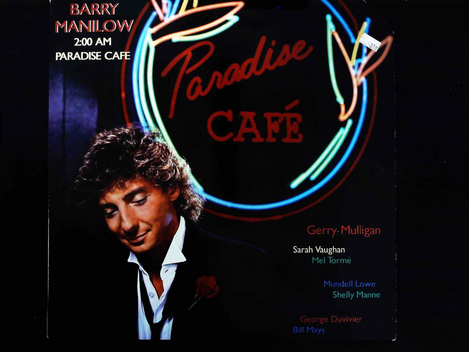 Barry Manilow 2:00 AM Paradise Cafe 1984 Arista LP: A 1984 release vinyl LP album titled 2:00 AM Paradise Cafe by Barry Manilow, released on the Arista label (Catalog No. AL8-8164). The album is a jazz-influenced work featuring collaborations with nota