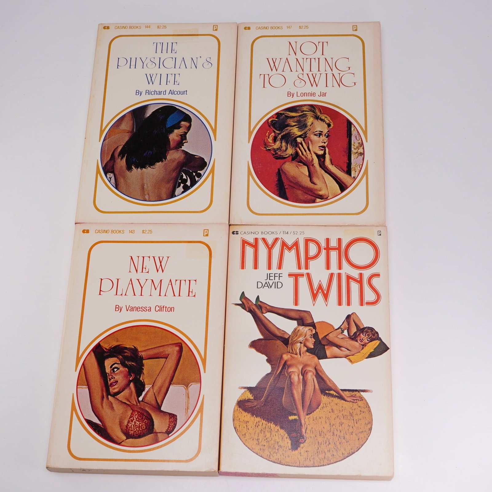 Four Piece Vintage Casino Soft Cover Books Erotica Fiction: Soft cover books included The Physician's Wife by Richard Alcourt; Not Wanting to Swing by Lonnie Jar; New Playmate by Vanessa Clifton and Nympho Twins by Jeff David. Books are used but in good condit