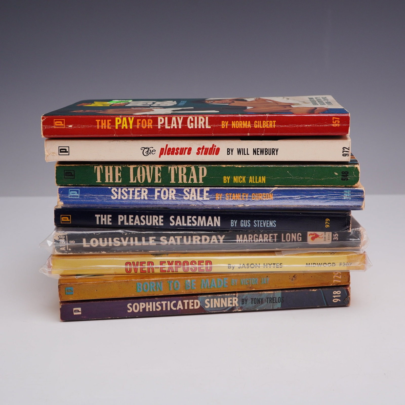 9pc Erotica Sleaze Pulp Fiction Paperbacks. Various Publishers, c. 1958-1965.: This 9-piece collection of vintage pulp fiction and "sleaze" paperbacks features a provocative assortment of mid-century adult-themed titles. The lot is primarily comprised of Brandon House publicatio
