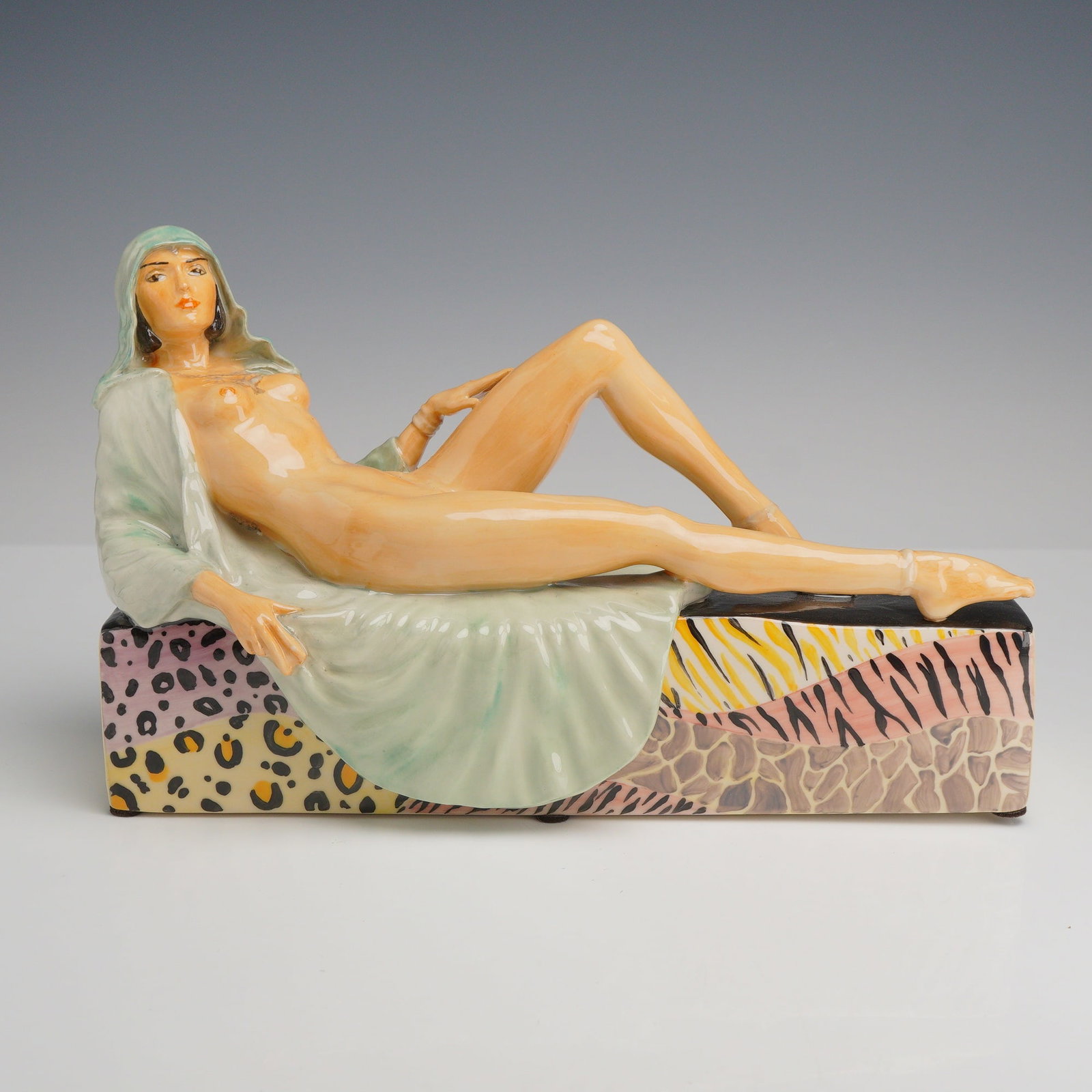 Peggy Davies Ceramics One-of-a-Kind Colorway Reclining Nude Figurine by Victoria Bourne: This contemporary Art Deco style glazed ceramic figurine, an artist original colorway for Peggy Davies by Victoria Bourne, depicts a reclining female nude. The figure is posed in an elongated, stylize