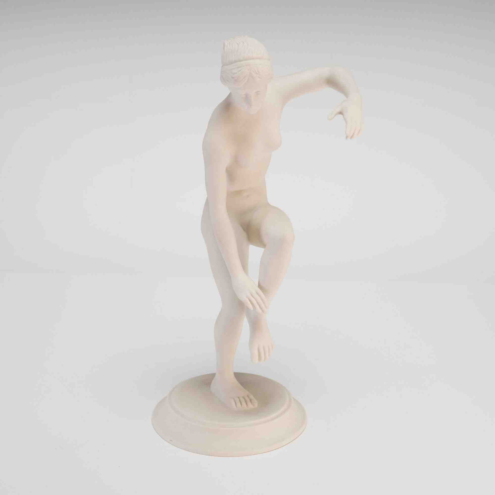 Boehm Pompeian and Herculanean Collection Bisque Porcelain Figurine, Aphrodite: A bisque porcelain figurine titled Aphrodite from the Pompeian and Herculanean Collection by Boehm. The figure depicts a nude female in a classical pose, standing on her left leg with her right leg ra
