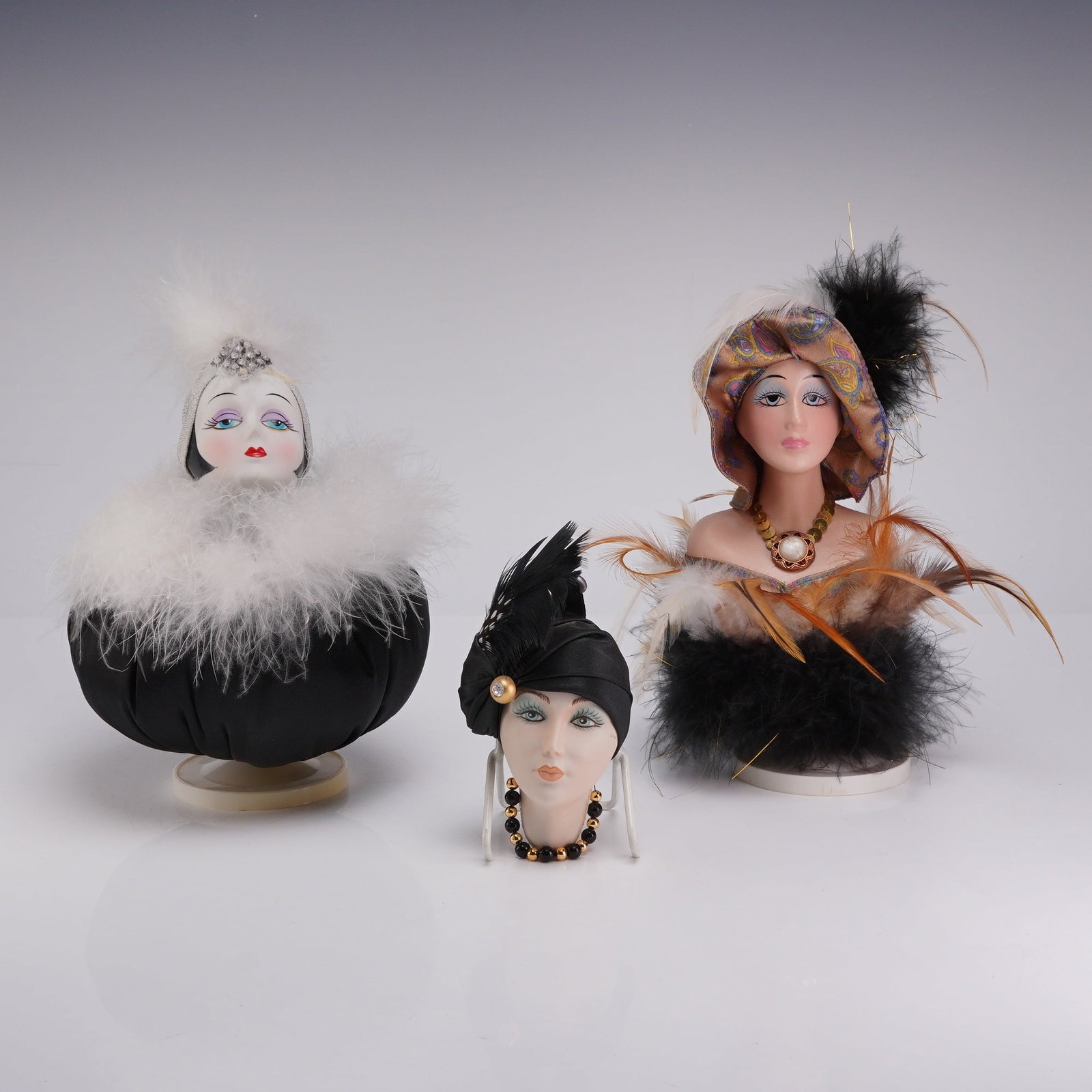 Three Bel Ombre Italy Porcelain Lady Head Bust Music Boxes and Ornament: This lot consists of three vintage decorative porcelain lady head busts designed in the Art Deco flapper style. Each figure features hand-painted facial details with prominent makeup and is embellishe