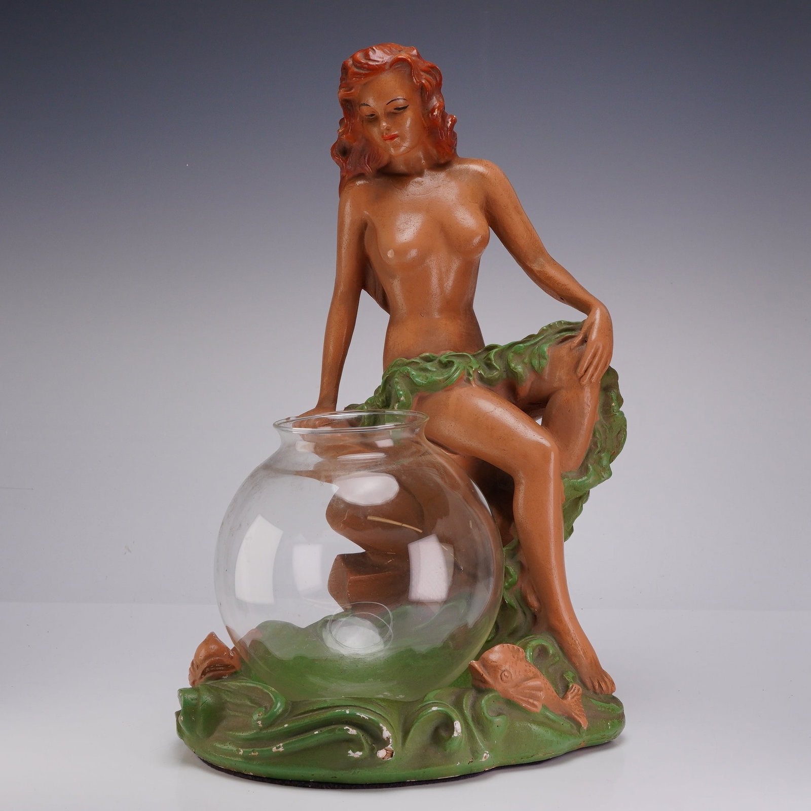 Mid-Century Nude Woman Figure with Clear Glass Bowl: This mid-20th-century decorative ensemble consists of a hand-painted chalk figure of a sexy woman and a coordinating clear glass bowl. The sculpture is crafted from a painted ceramic material, likely 