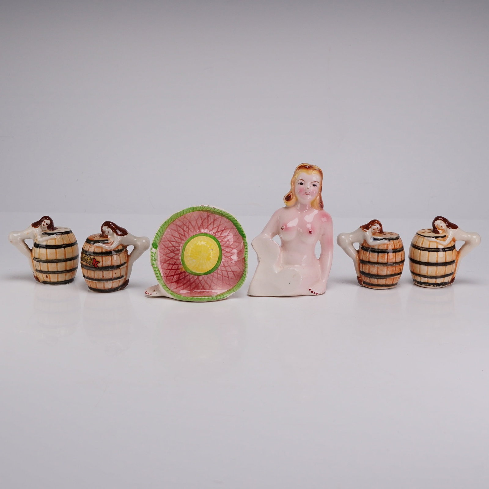 6pc Japanese Risque Novelty Ceramic Salt & Pepper Shakers: This collection of novelty ceramic salt and pepper shakers was produced in Japan during the mid-20th century. The group includes four shakers modeled as wooden-style barrels with a female figure