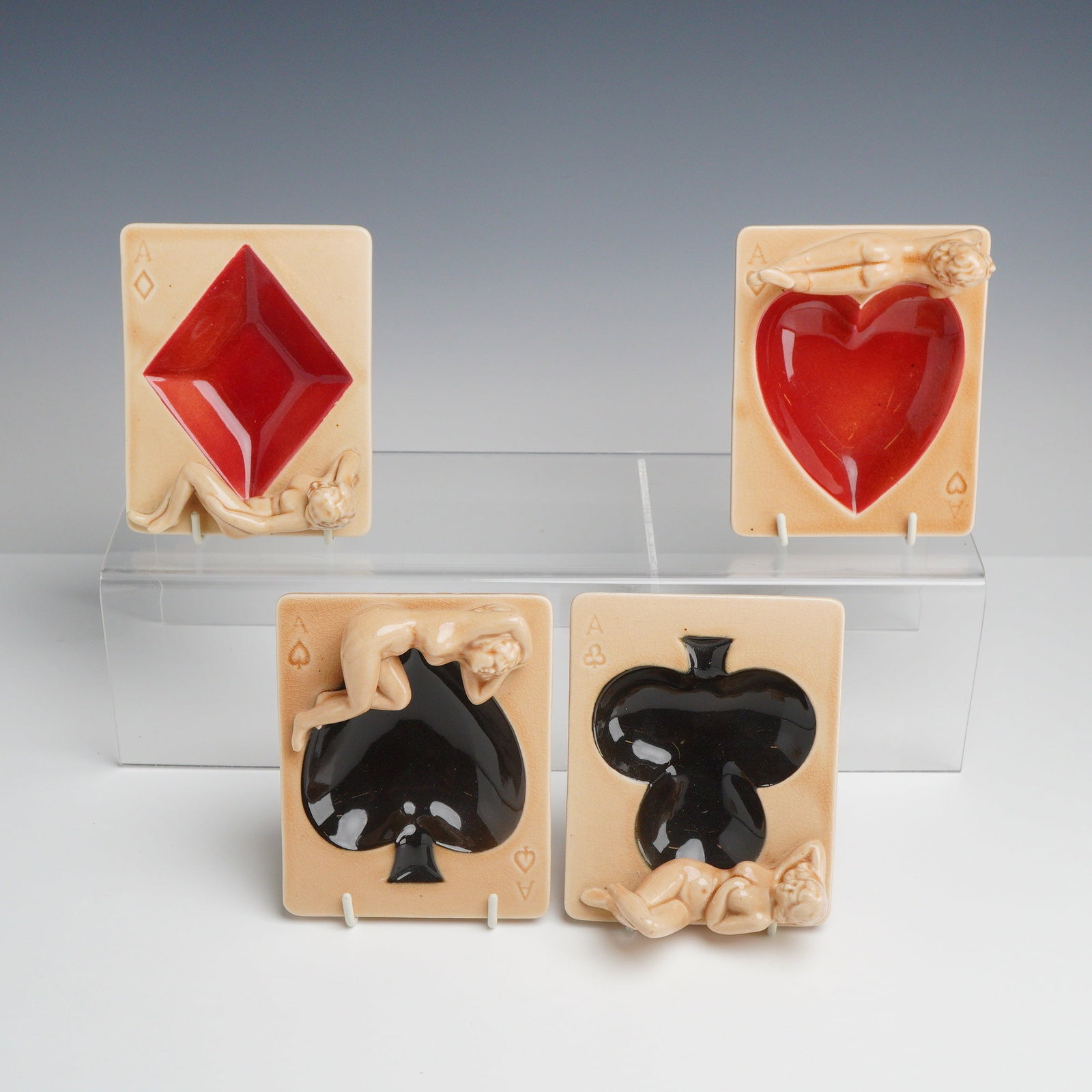 Set of Four Shafford Japan Nude Pin-Up Playing Card Ceramic Ashtrays: A set of four mid-century glazed ceramic novelty ashtrays manufactured by Shafford in Japan. This set comprises four trays designed as the Aces from a deck of cards: Hearts, Diamonds, Clubs, and Spade
