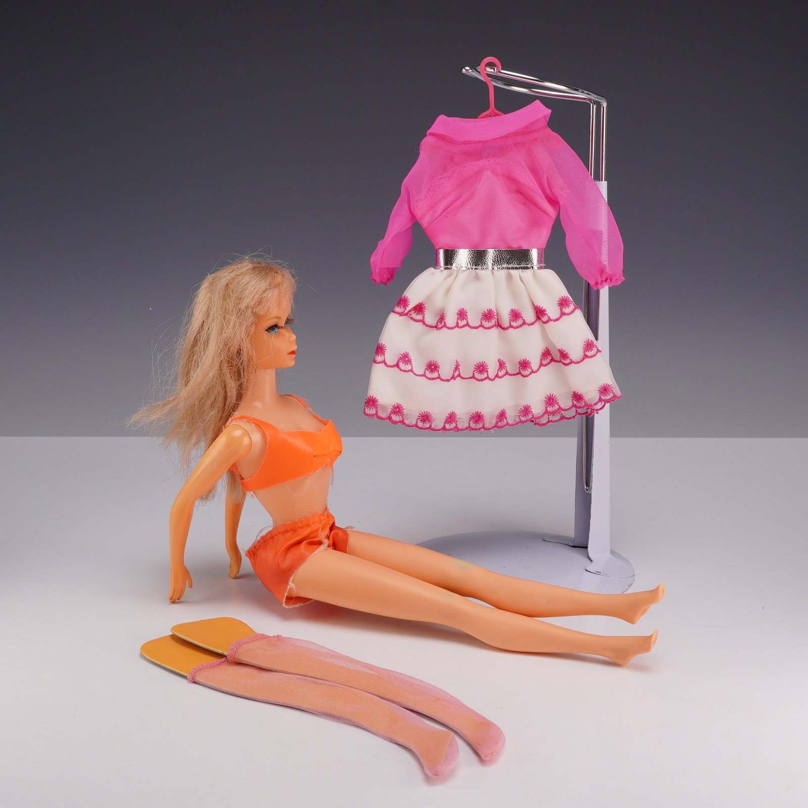1966 Mattel Twist N Turn Barbie Doll and Happy Go Pink Outfit: This set features a vintage 1966 Mattel Twist N Turn Barbie doll accompanied by the Happy Go Pink fashion ensemble. The doll is constructed of vinyl with a rotating waist and bendable legs. It