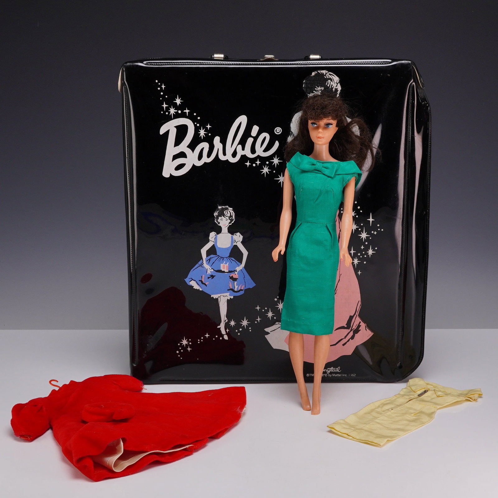 Barbie Accessory Carrying Case with Brunette Doll, Red Flair Outfit, and Yellow Dress: This 7pc Barbie lot features a brunette Mattel Barbie doll from 1961 and associated accessories. The doll is constructed of vinyl and features rooted hair in a brunette bubble-cut style. It has
