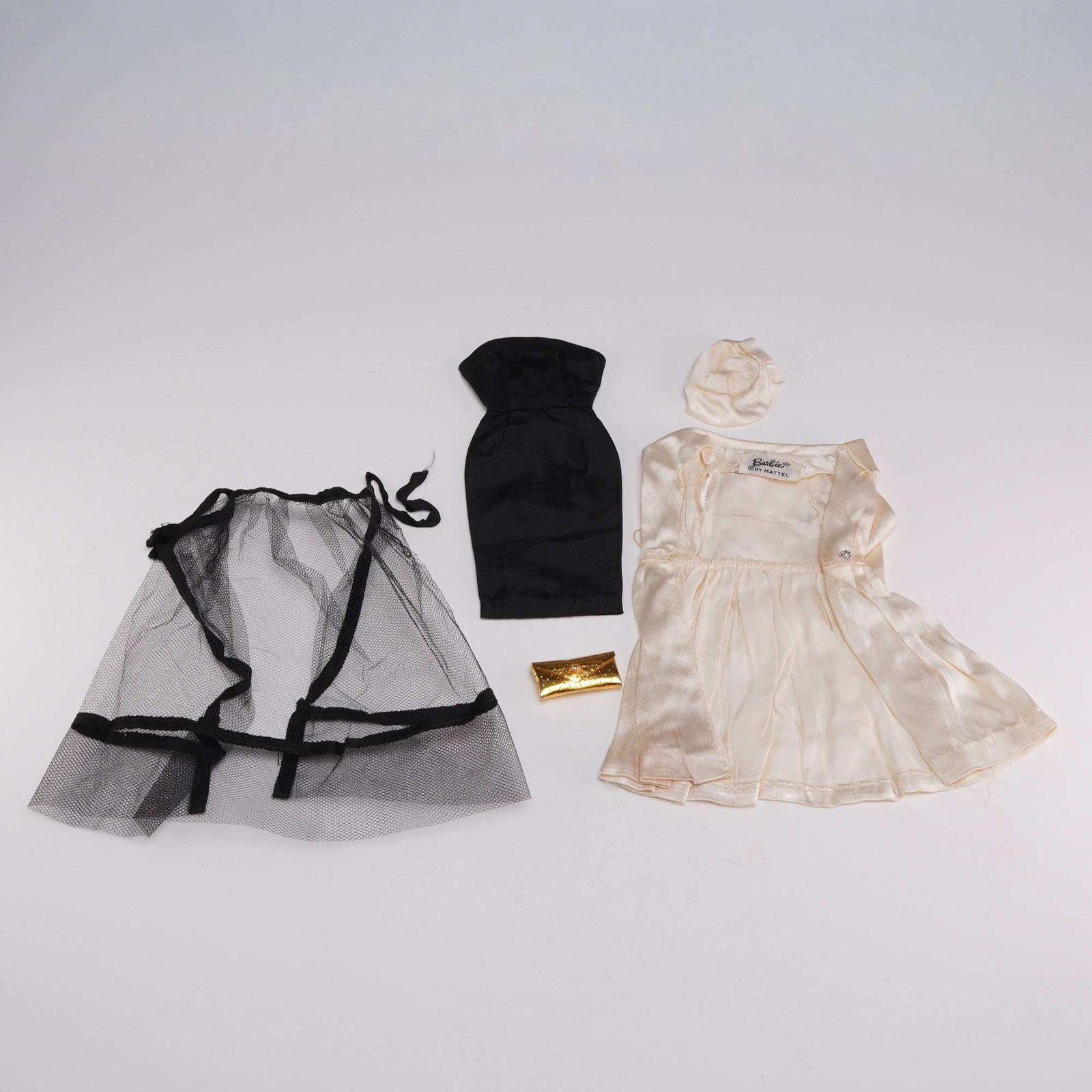 Vintage Barbie 2pc Outfits White Magic and Black Magic by Mattel: A group of vintage doll fashions manufactured by Mattel for the 11.5-inch Barbie doll, comprising the 2pc outfits known as White Magic and Black Magic. One garment retains an original woven fabric