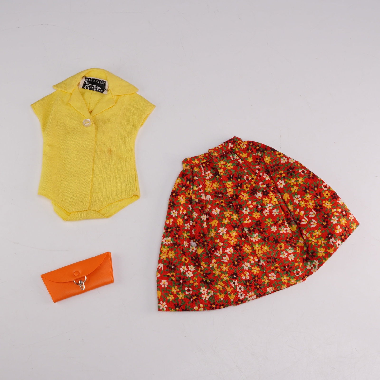 Vintage Mattel Barbie Country Fair Outfit #1603 with Blouse Skirt and Clutch Purse: This vintage three-piece doll ensemble is identified as the Country Fair outfit, reference #1603, produced by Mattel for the 11.5-inch Barbie doll circa 1964. The set consists of a yellow bodysuit-sty
