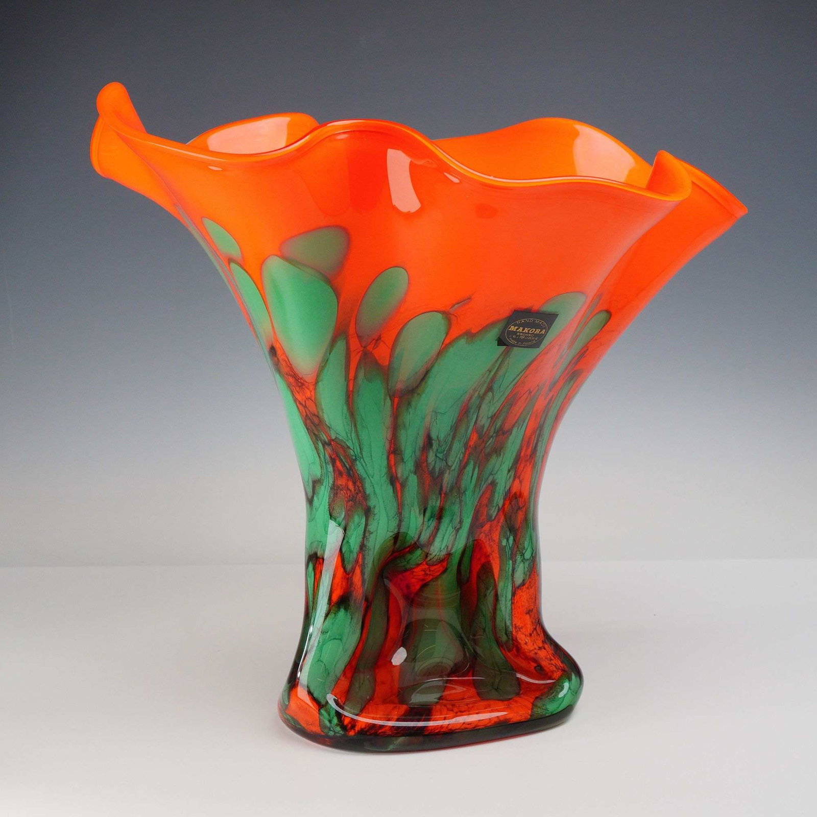 Makora Krosno Poland Cauliflower Art Glass Vase: This hand-blown art glass vase was manufactured by Makora in Krosno, Poland. The vessel is formed in a trumpet shape with a wide, deeply ruffled and undulating rim. The upper section consists of