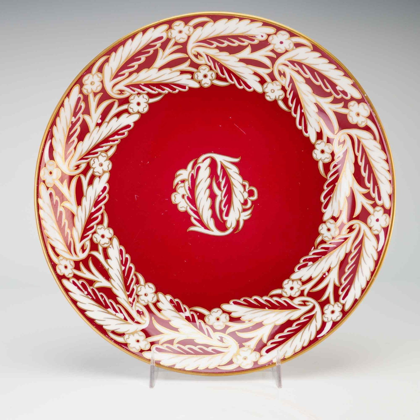 Wedgwood Bone China Renaissance Red Service Plate with Gilt: This Wedgwood (WW) bone china service plate features a circular form with a recessed center and a broad, flat rim. The decoration consists of a rich ruby red ground embellished with a wide border of