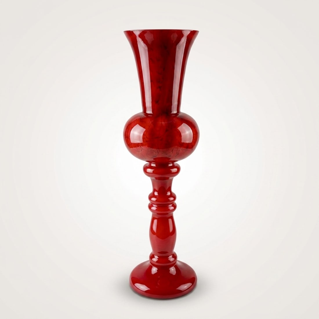 Makora Krosno Polish Monumental Ruby Red Art Glass Stemmed Trumpet Vase: Executed in richly toned ruby red glass cased over a white opalino interior using the incamiciato technique. The elegant form features a flared trumpet rim rising from a long tapering neck into a