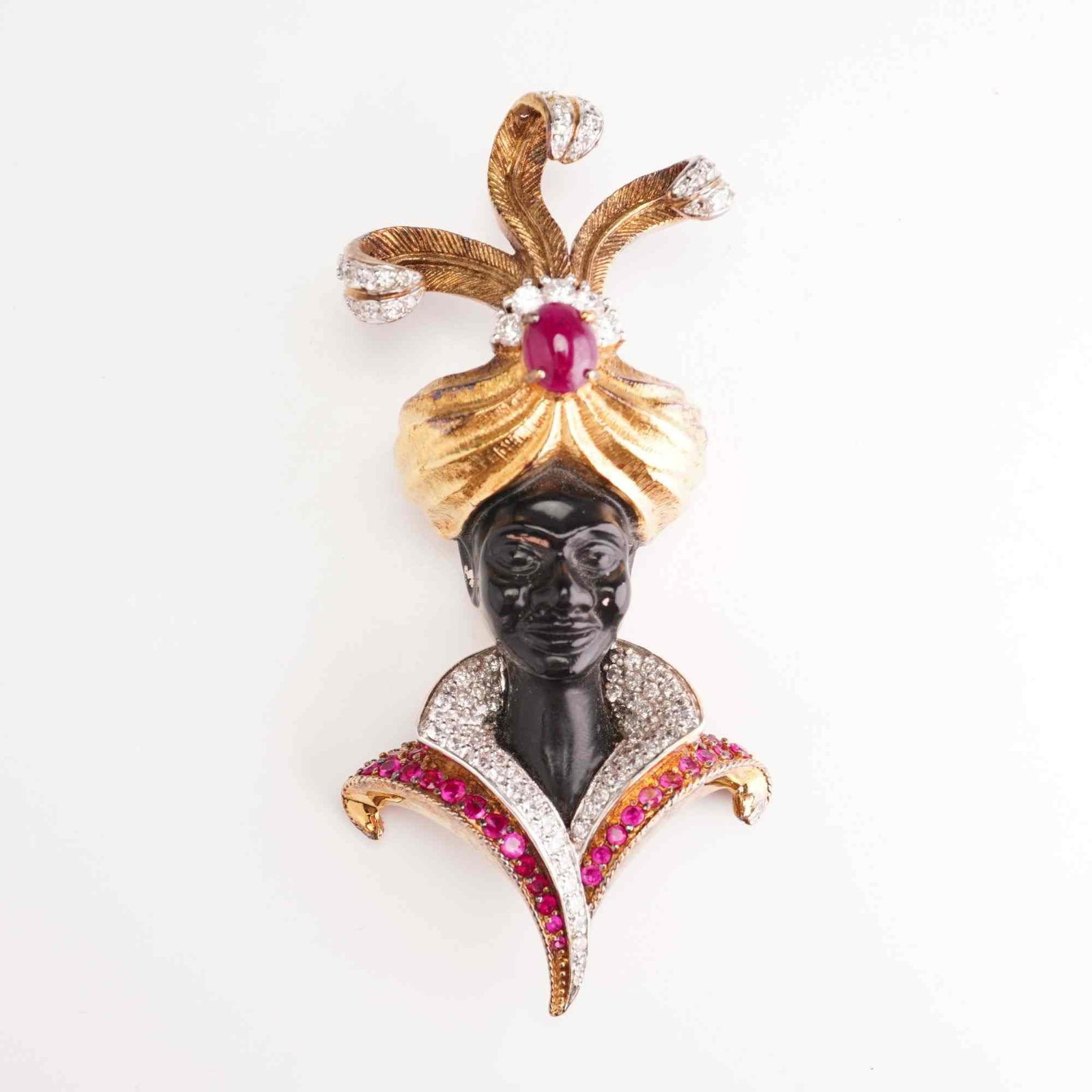 Jarin Sterling Silver Vermeil Blackamoor Brooch: A rare mid-century Blackamoor bust brooch by the designer Jarin. The piece is constructed from sterling silver with a gold-tone vermeil finish. The motif features the head and shoulders of a figure we