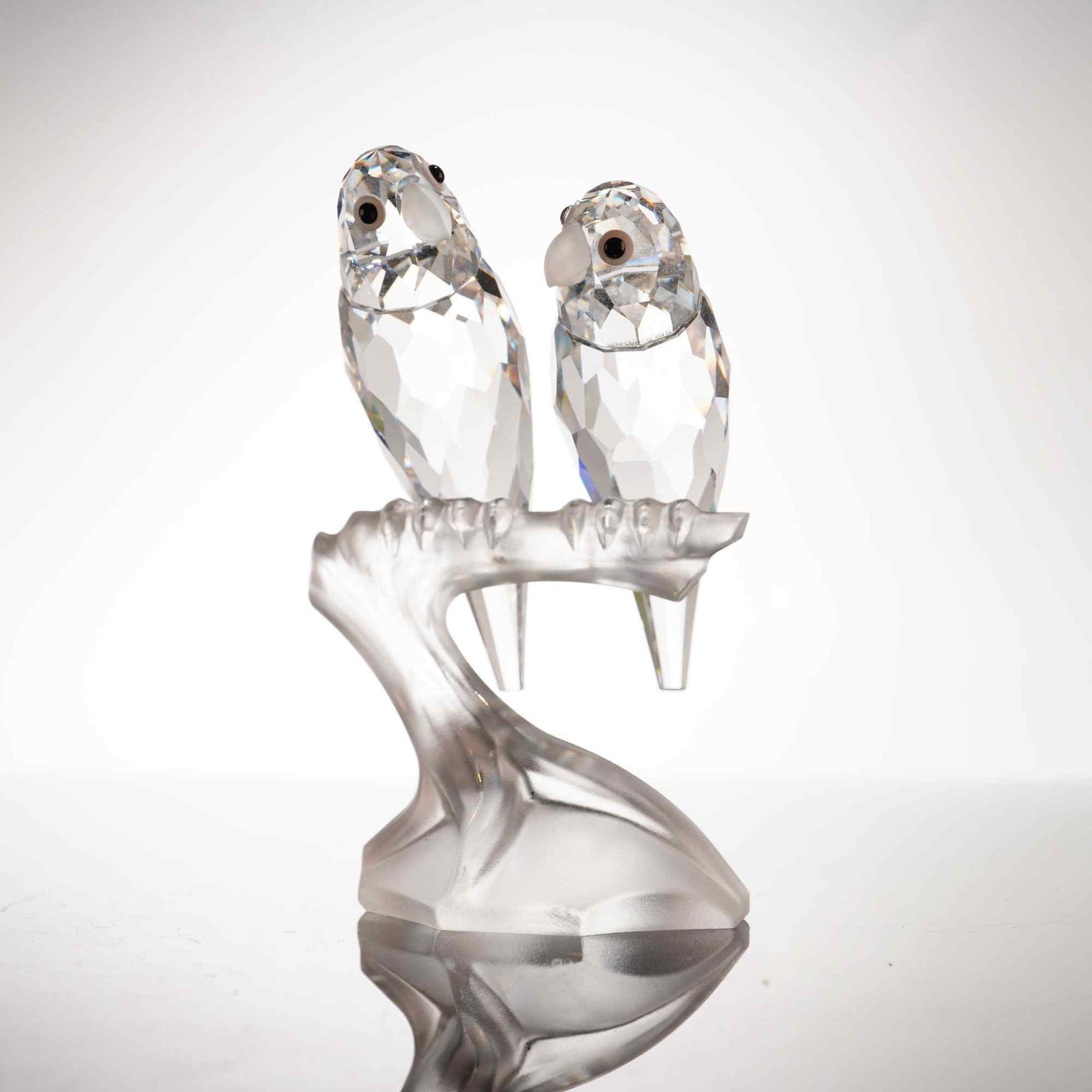 Swarovski SCS Annual Edition 1987 Togetherness Lovebirds Crystal Figurine: This Swarovski lead crystal figurine depicts two budgerigars, commonly known as lovebirds, perched on a branch. Titled Togetherness, this piece was the first annual edition produced exclusively for th