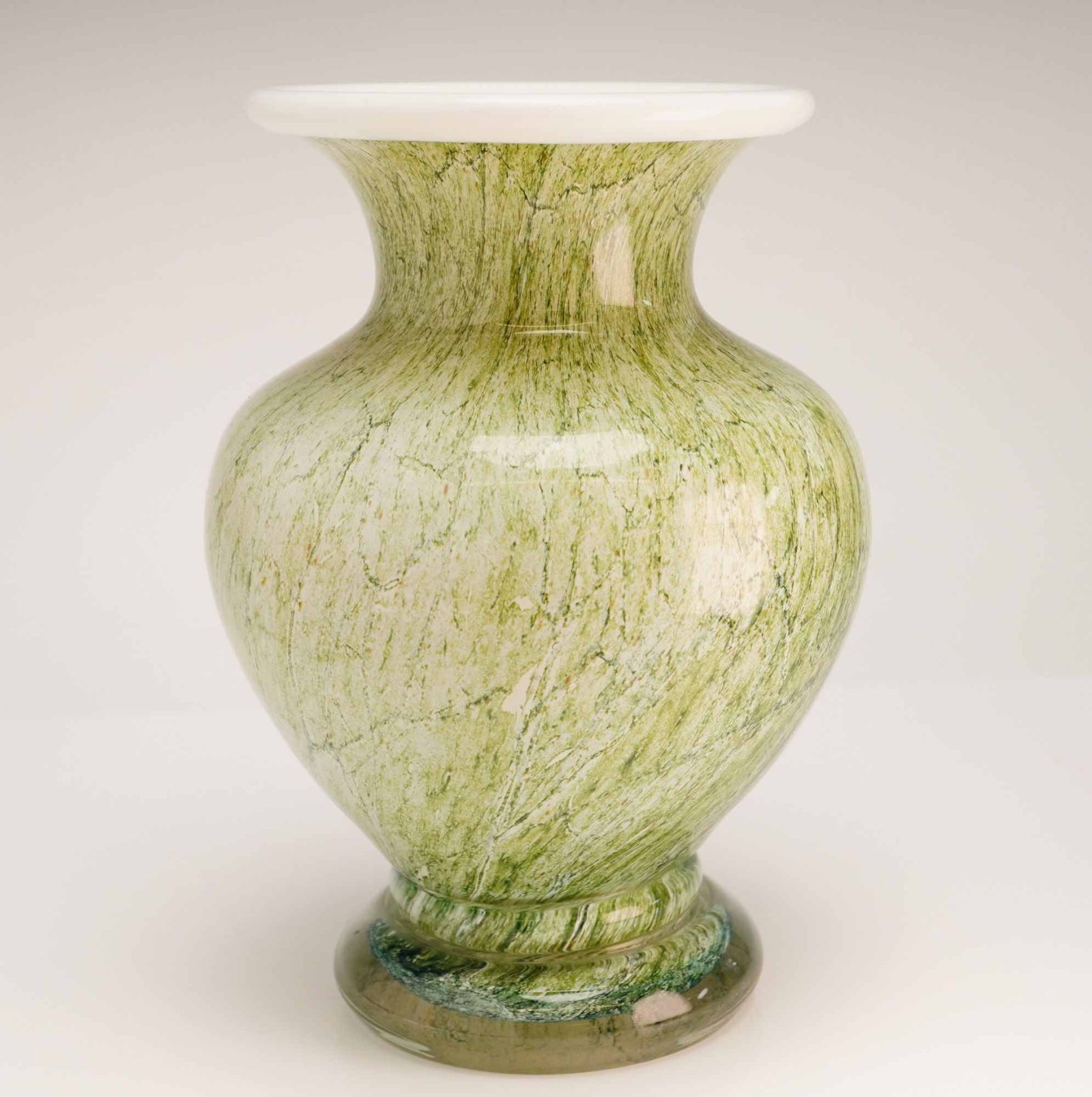 Jozefina Krosno Marbled Green Art Glass Vase: A hand-blown art glass vase of bulbous form manufactured by the Jozefina glassworks in Krosno, Poland. The vessel features a variegated green and cream marbled finish throughout the body, intended to 