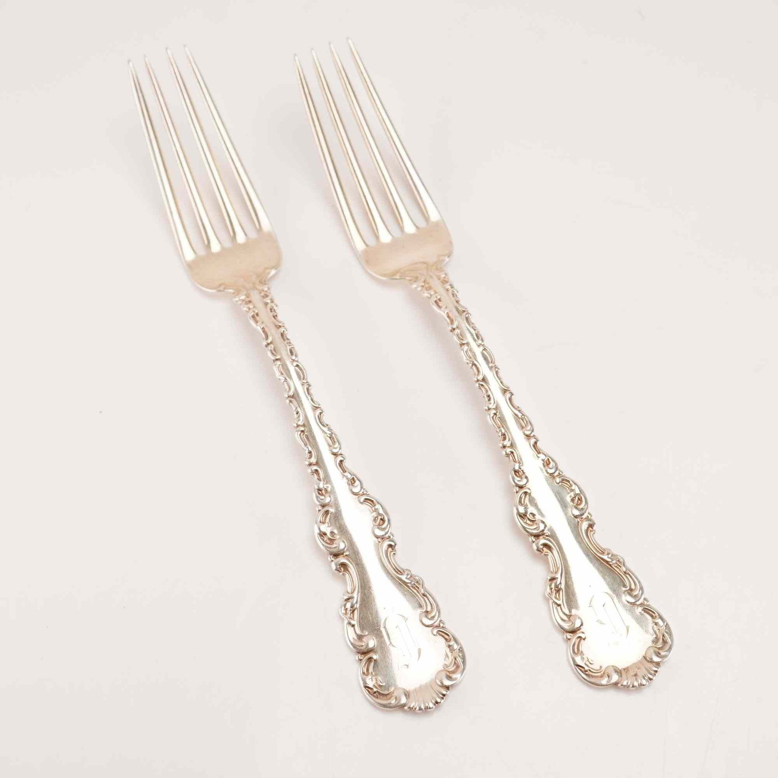 2pc Whiting Manufacturing Company Sterling Silver Forks, Louis XV Pattern: A pair of solid sterling silver forks in the Louis XV pattern, produced by the Whiting Manufacturing Company and first introduced in 1891. The forks feature a Rococo Revival style design with scrollin