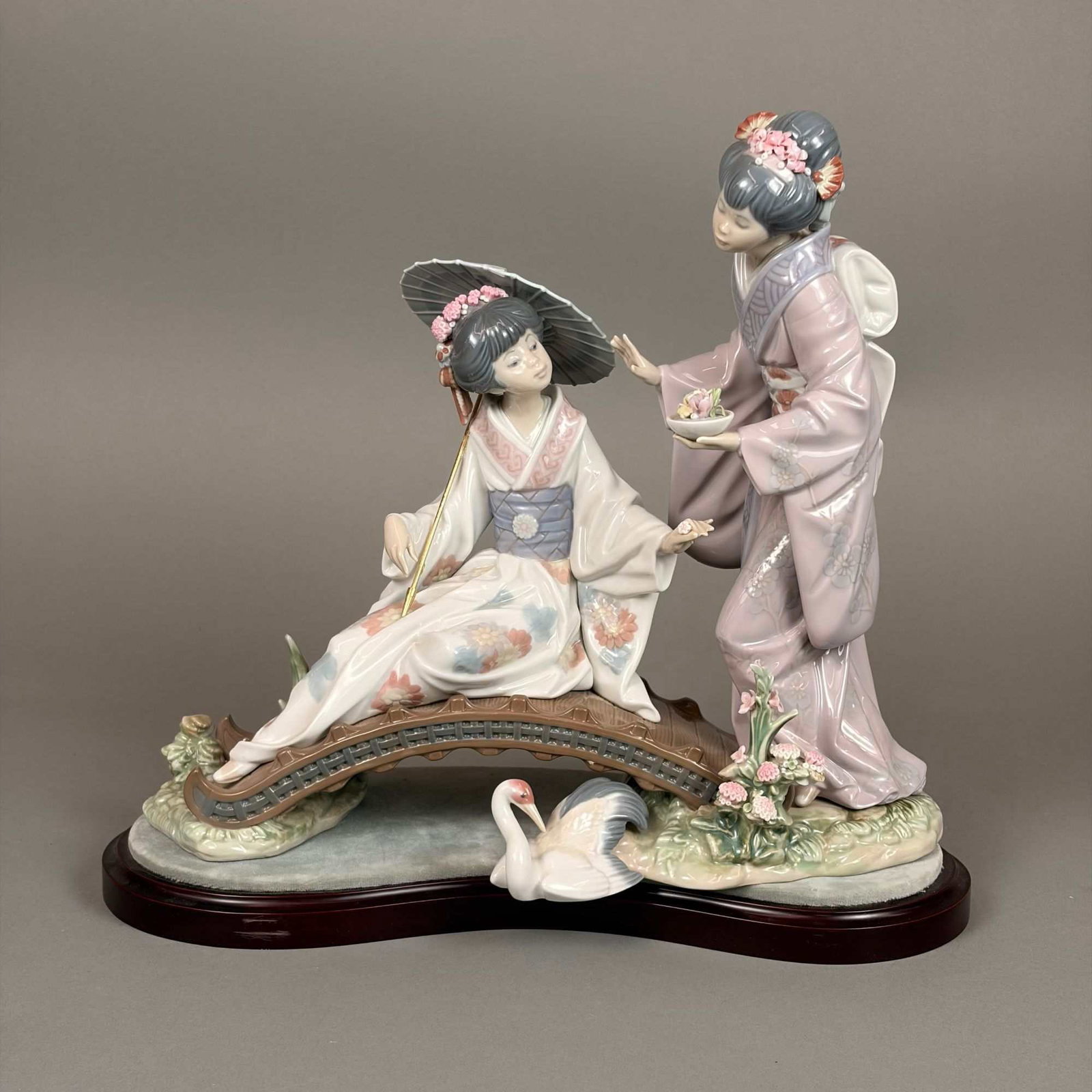 Lladro Glazed Porcelain Figurine with Box and Base, Springtime in Japan 01001445: This is a Lladro glazed porcelain sculptural group titled Springtime in Japan, model number 01001445. Designed by sculptor Salvador Debon and issued in 1983, the scene features two Japanese women in t