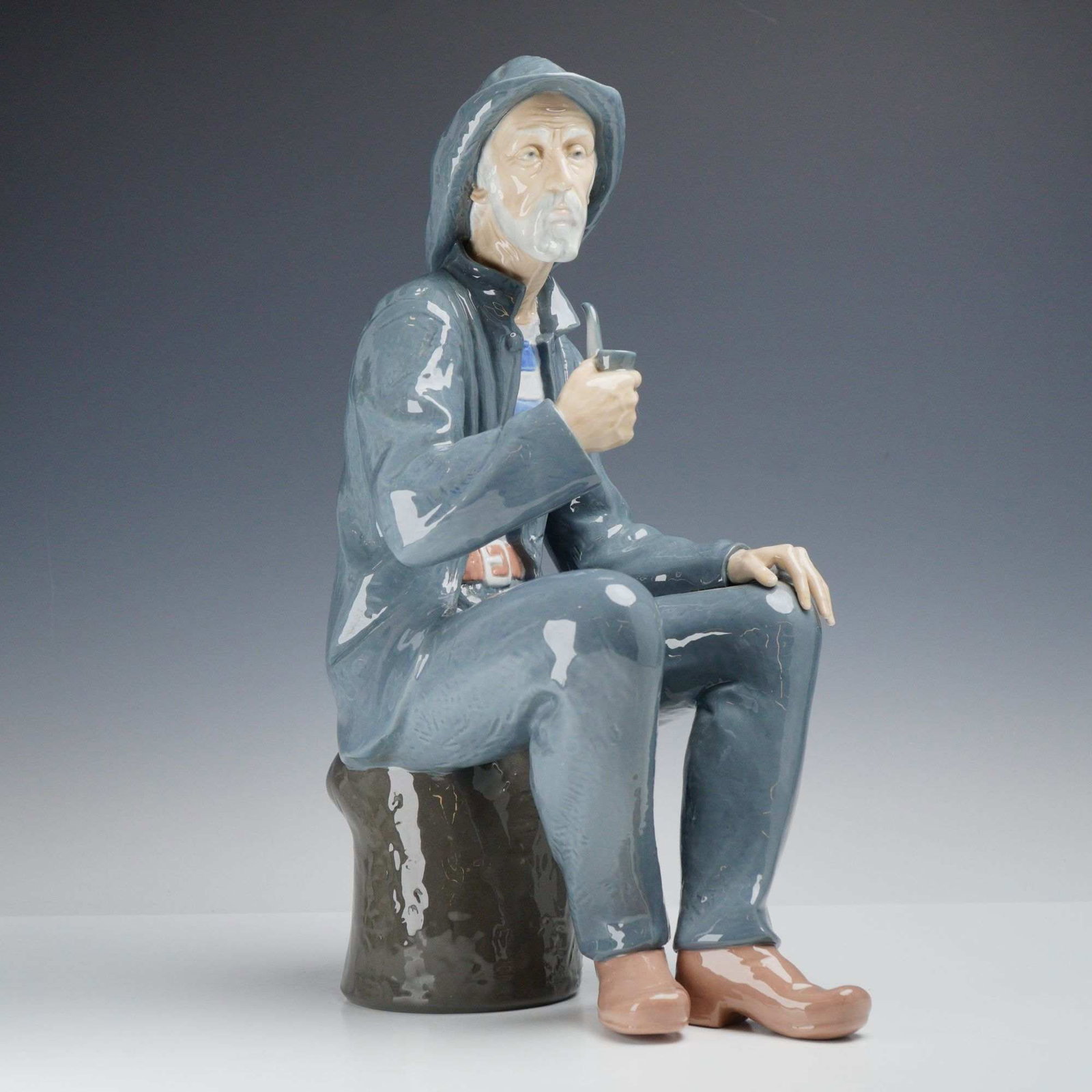 Nao by Lladro Glazed Porcelain Figurine, Seated Fisherman with Pipe (1 of 3)
