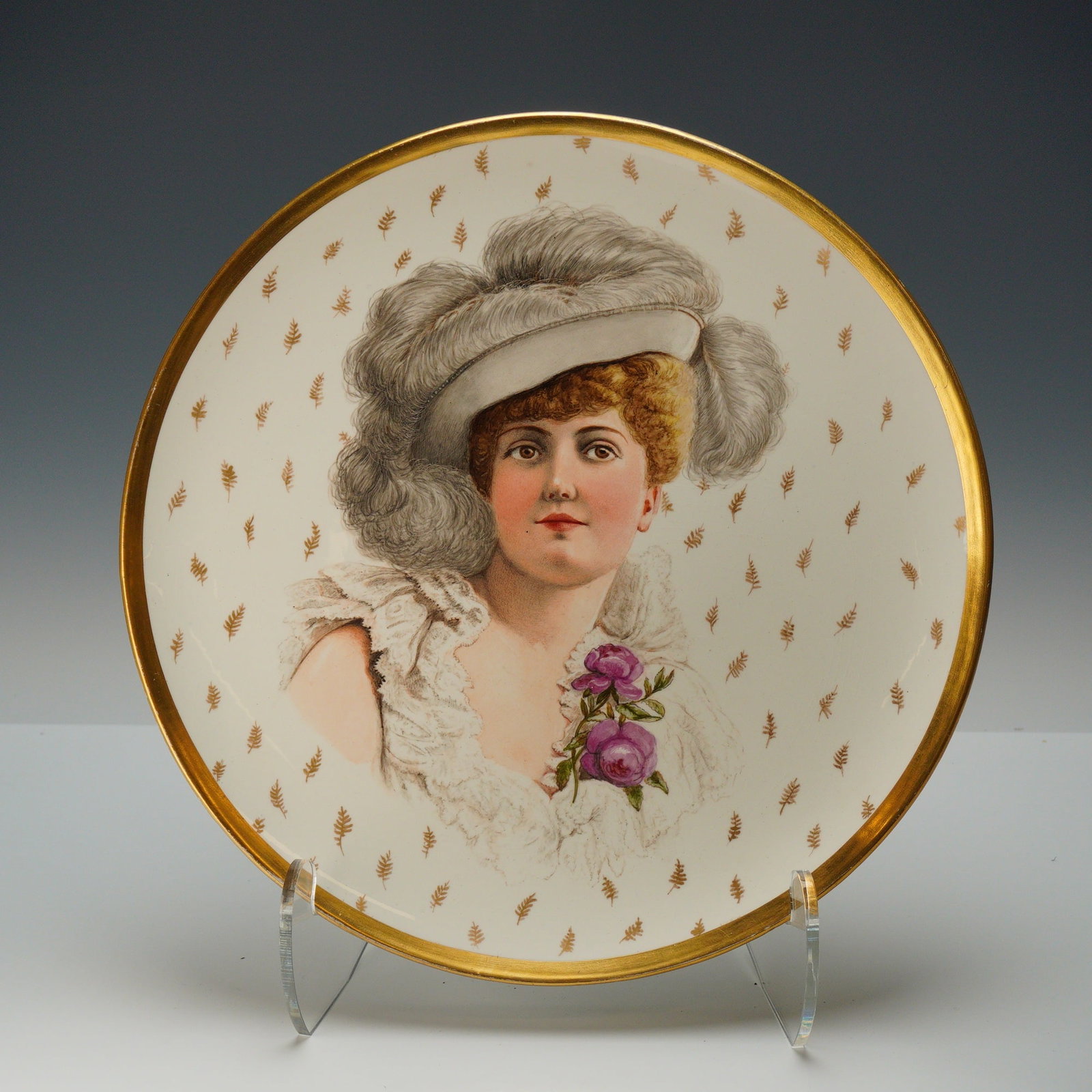 Wedgwood Portrait Cabinet Plate: This Wedgwood porcelain cabinet plate is decorated in the Royal Vienna style and features provenance from the Rubin Collection. The center of the plate contains a hand-painted portrait of a woman in l