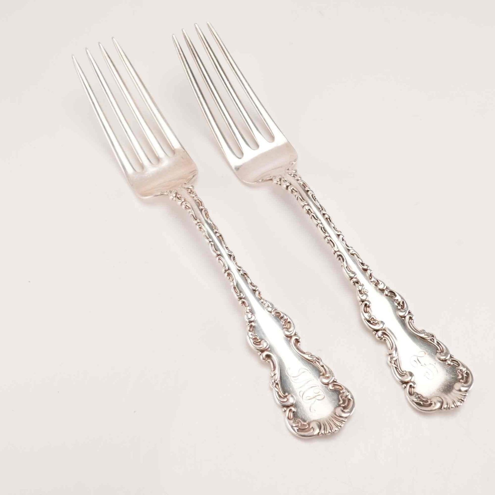 2pc Whiting Manufacturing Company Sterling Silver Forks, Louis XV Pattern: This pair of solid sterling silver forks is in the Louis XV pattern, produced by the Whiting Manufacturing Company. The pattern was patented in 1891, as indicated by the marks on the reverse. The desi