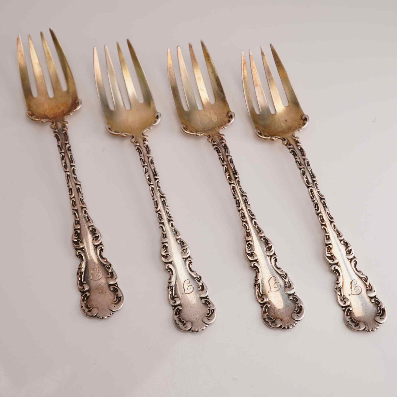 4pc Whiting Manufacturing Company Sterling Silver Table Forks, Louis XV: A set of four sterling silver table forks produced by the Whiting Manufacturing Company in the Louis XV pattern, which was patented in 1891. Each piece is crafted from solid .925 sterling silver and f