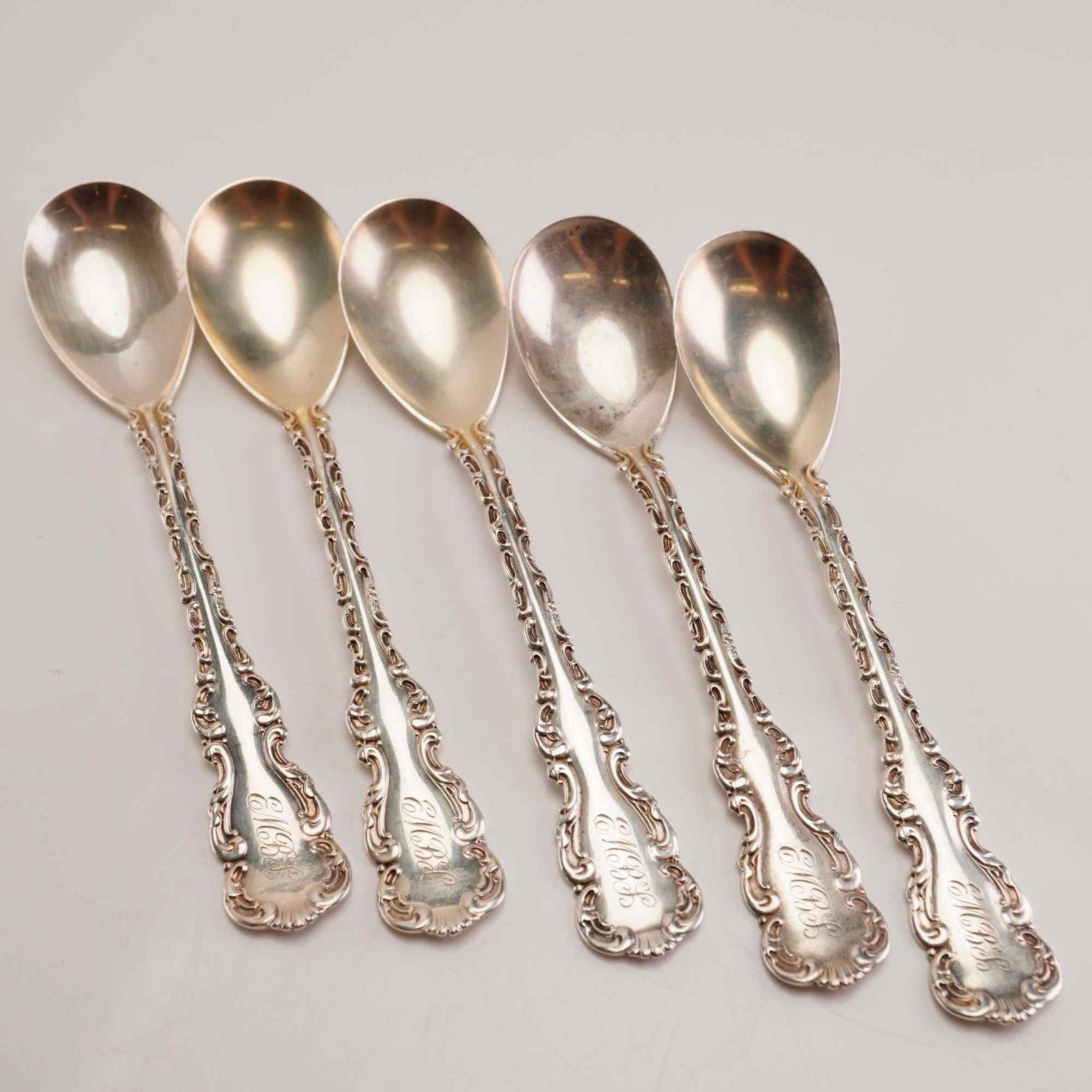 5pc Whiting Manufacturing Company Sterling Silver Teaspoons, Louis XV: A set of five sterling silver teaspoons produced by the Whiting Manufacturing Company in the Louis XV pattern, originally patented in 1891. The spoons exhibit a highly ornate Rococo Revival design fea