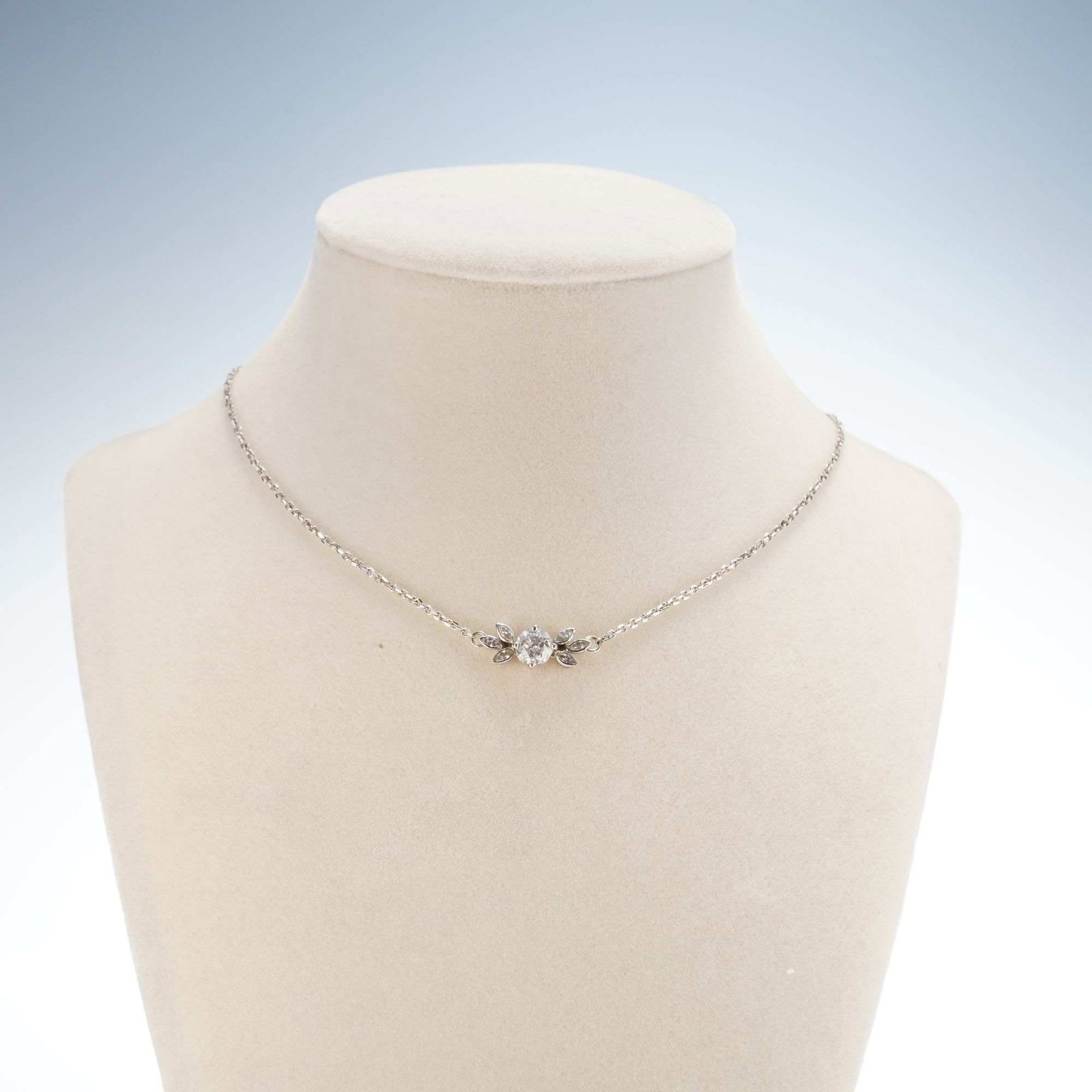 14K White Gold 1ctw Diamonds Pendant Necklace: A white gold necklace featuring a central pendant with one round diamond surrounded by six marquise-cut diamonds, with a total combined weight of approximately 1 carat. The tag near the clasp is