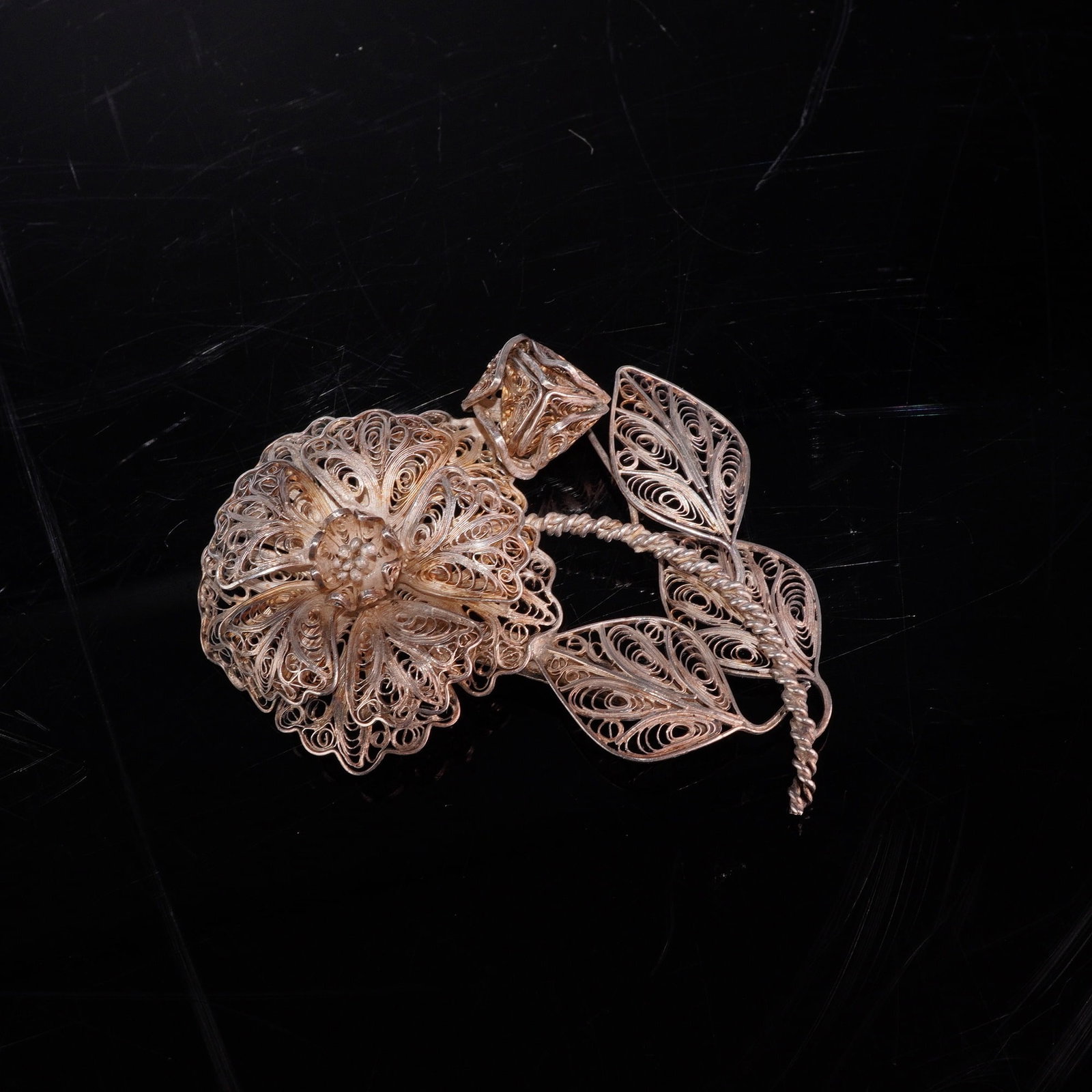 Mexican Silver Filigree Floral Leaf Design Pin Brooch: This vintage silver filigree jewelry piece is a pin brooch featuring a detailed leaf design and botanical motif. The brooch depicts a large flower blossom with multiple layers of petals and a