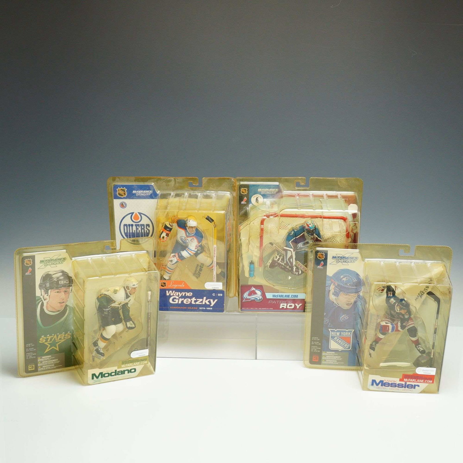 A Set of 4 McFarlane Toys NHL Sportspicks Hockey Action Figures: This set of four NHL hockey action figures is produced by McFarlane Toys as part of the McFarlane's Sportspicks product line. Each figure is presented in its original, unopened blister pack packaging.