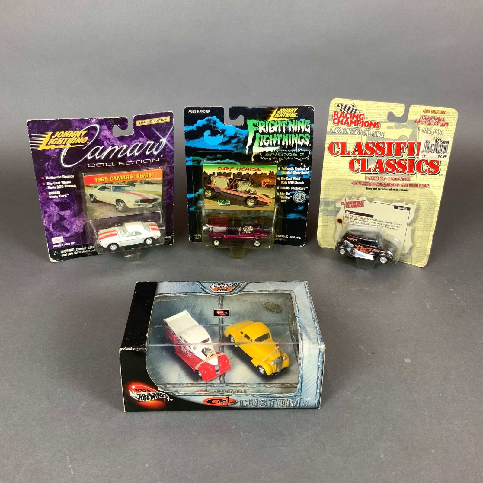 An Assortment of 4 NASCAR Model Cars and Die-Cast Vehicles by Johnny Lightning, Racing Champions, (1 of 3)